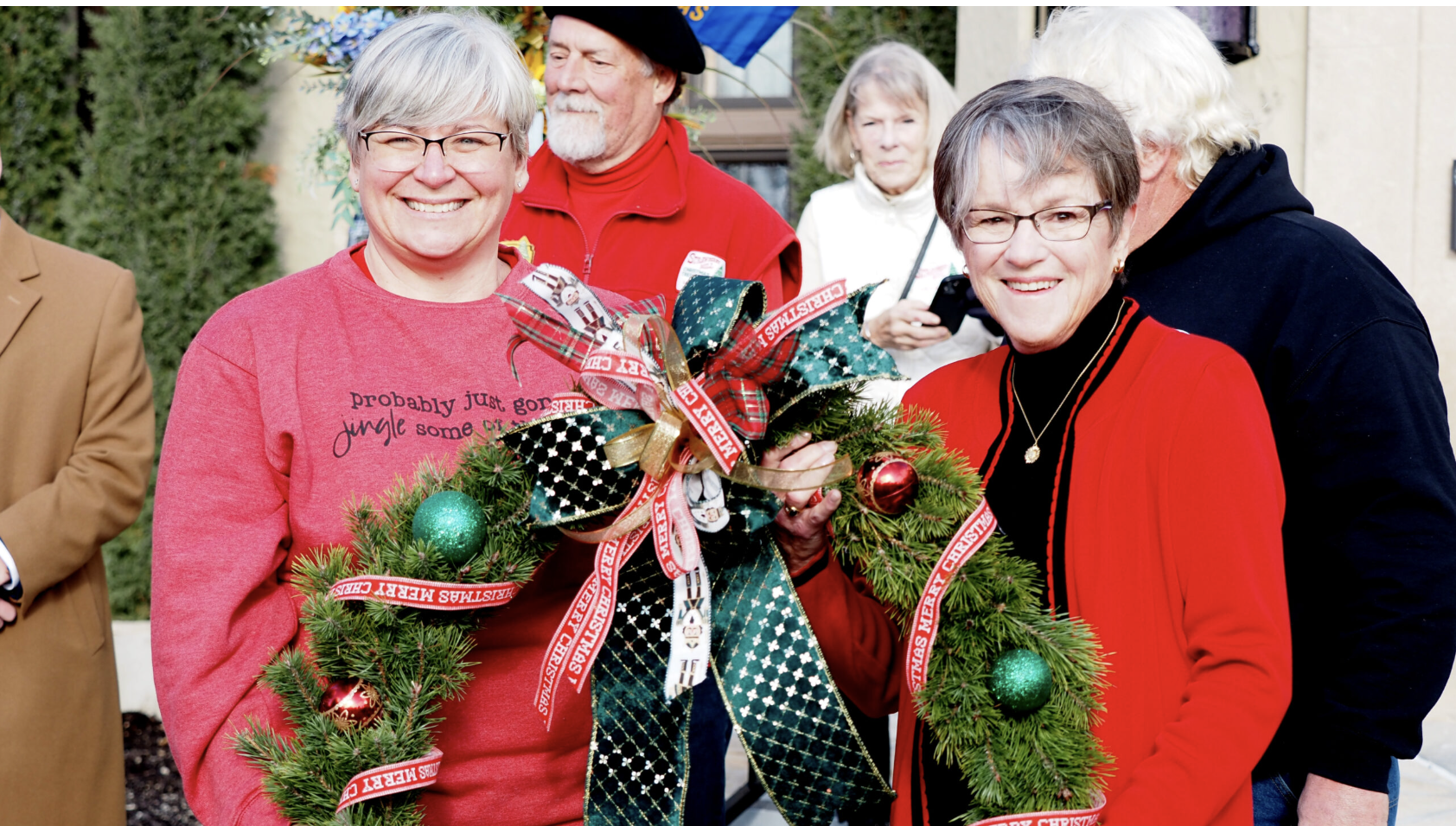 Chris Seets presents the wreath she made to Gov. Laura Kelly on Nov. 25, 2025, at Cedar Crest in Topeka. (Photo by Grace Hills for Kansas Reflector)