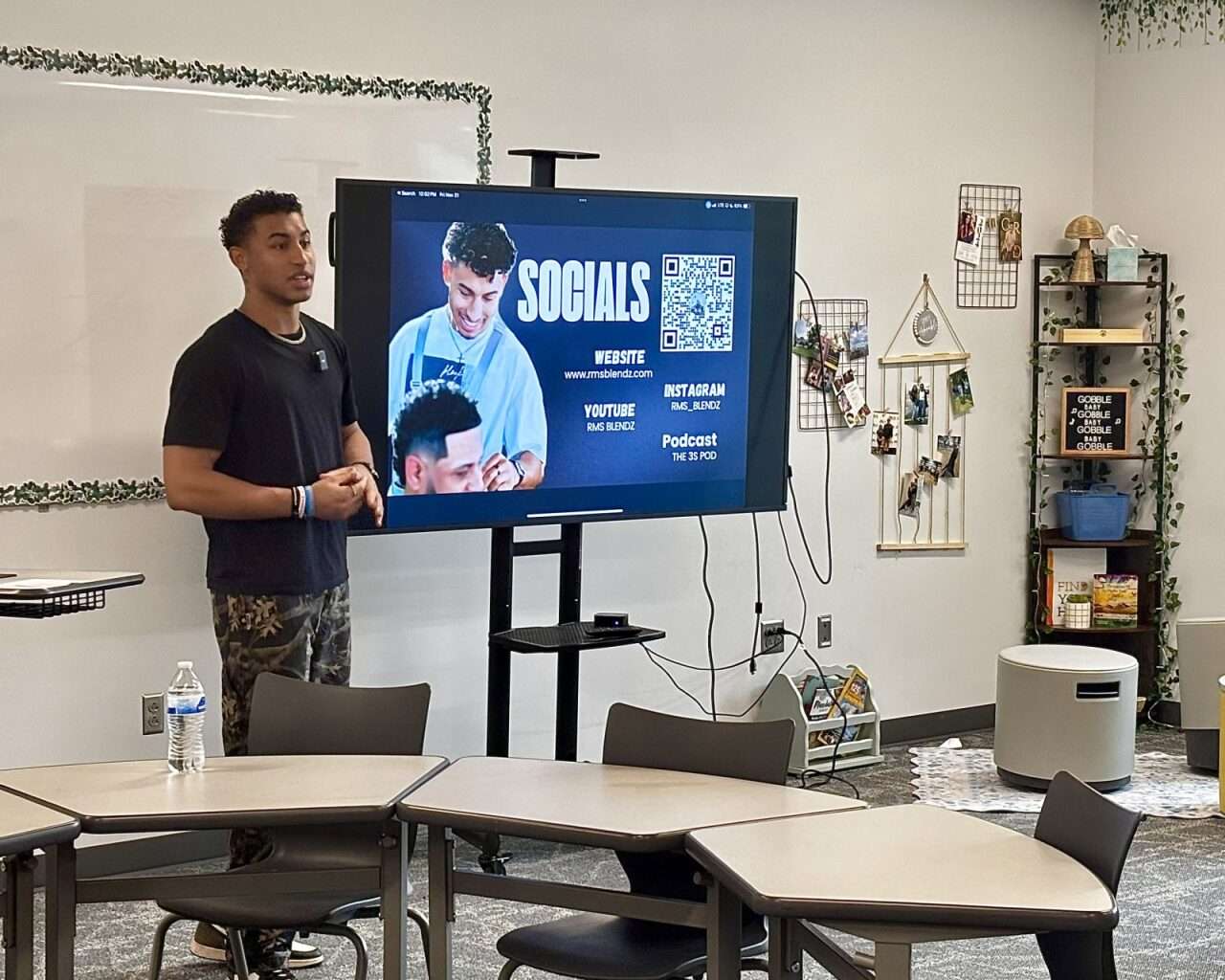 Remy Stull, barber at Fade Factory in Hays, giving a presentation to Hays High School students in the JAG-K program about his career after high school. Photo by Tony Guerrero/Hays Post