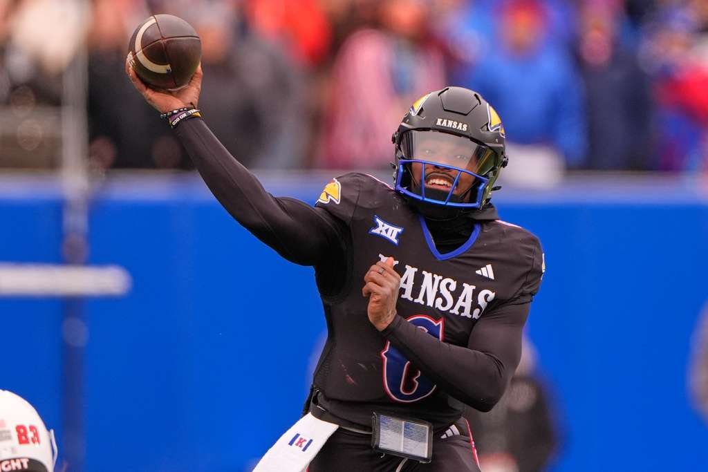 Kansas quarterback Jalon Daniels passes the ball during the first half of an NCAA college football game against Utah, Friday, Nov. 28, 2025, in Lawrence, Kan. (AP Photo/Charlie Riedel)