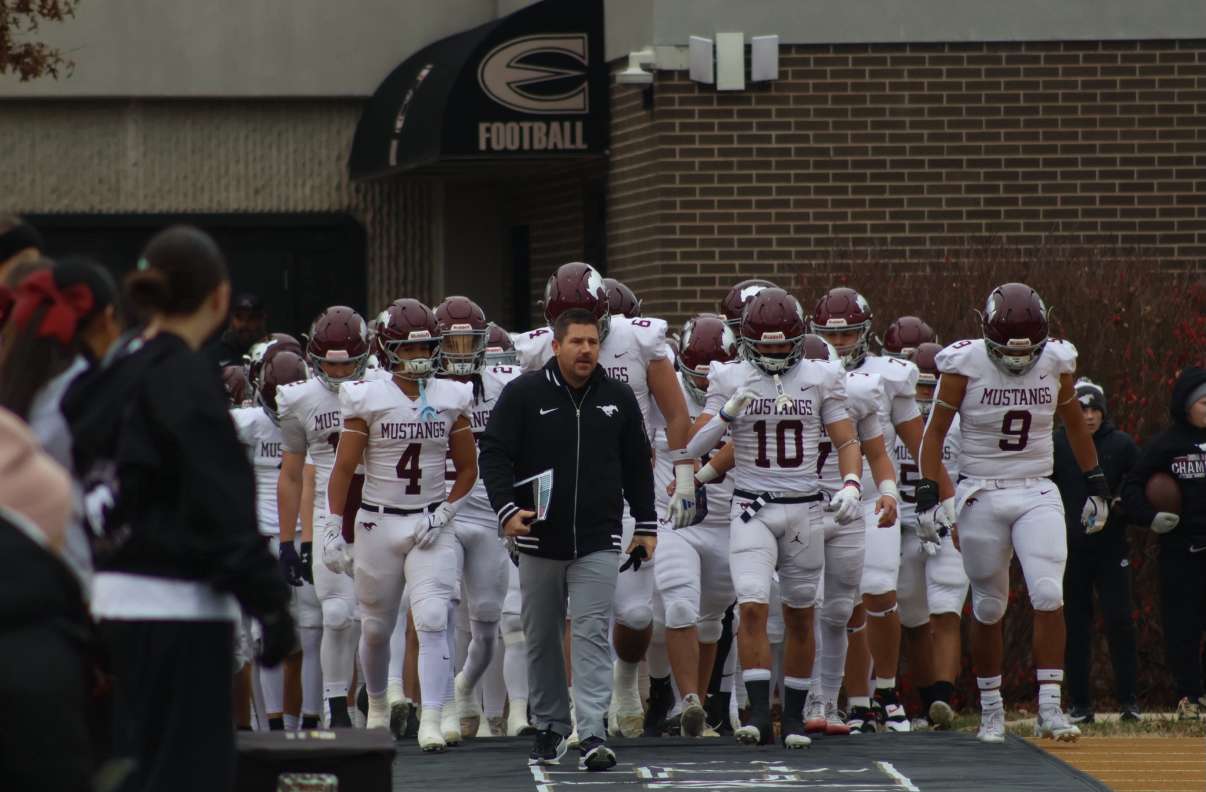 The Mustangs take the field, led by head coach Mark Sandbo - Photo courtesy of Kaiden Comeau.
