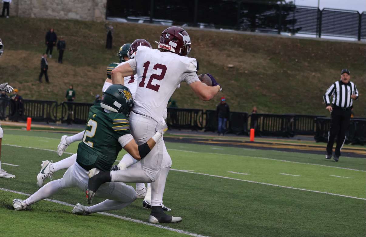 A Bobcat defender does his best to tackle Cooper Reves - Photo by Kaiden Comeau.