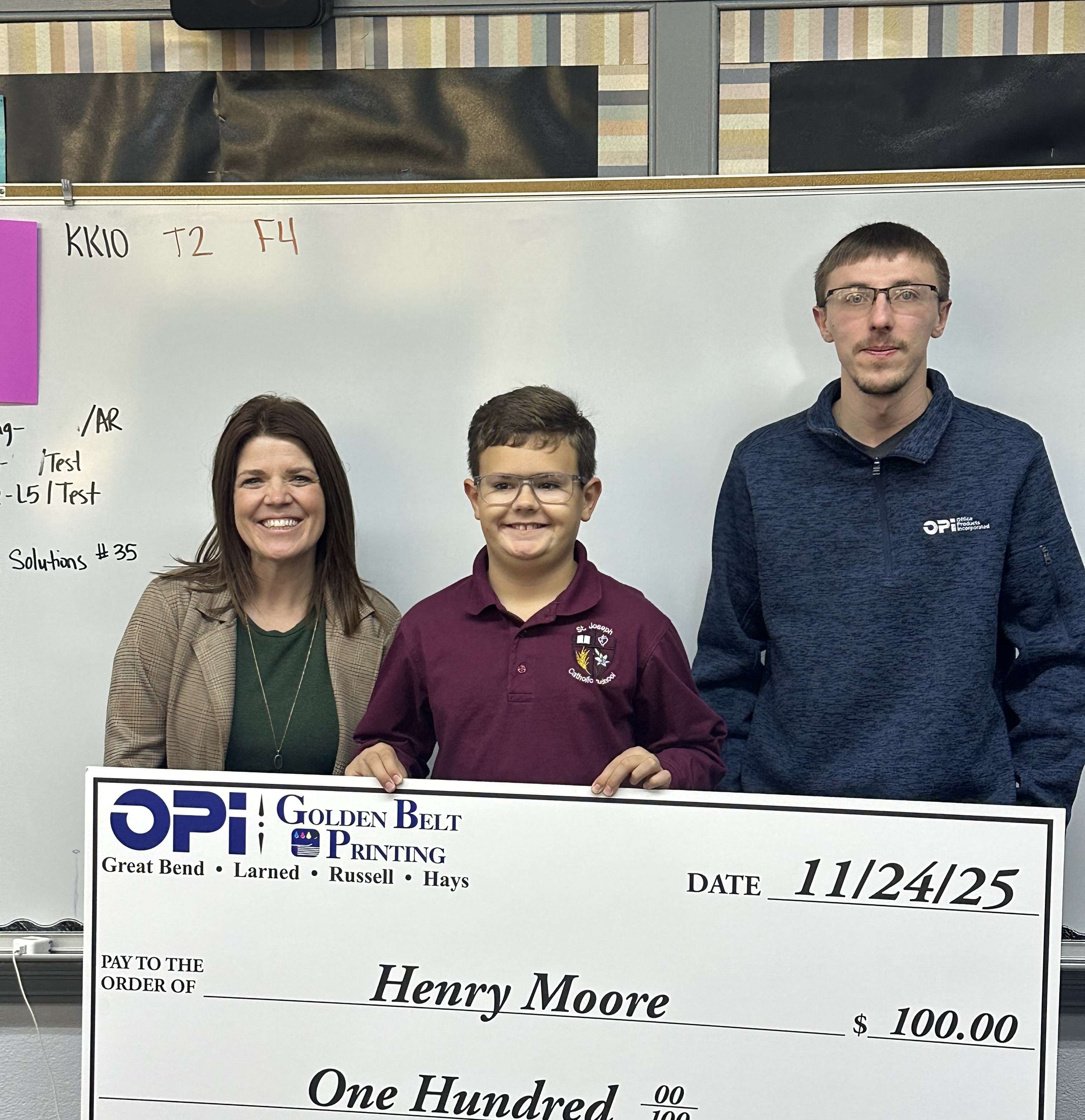 OPI & Golden Belt Printing presented St. Joseph Catholic School fifth grader Henry Moore with a giant $100 check as the final November weekly winner in Eagle Media's Make a Difference Contest.