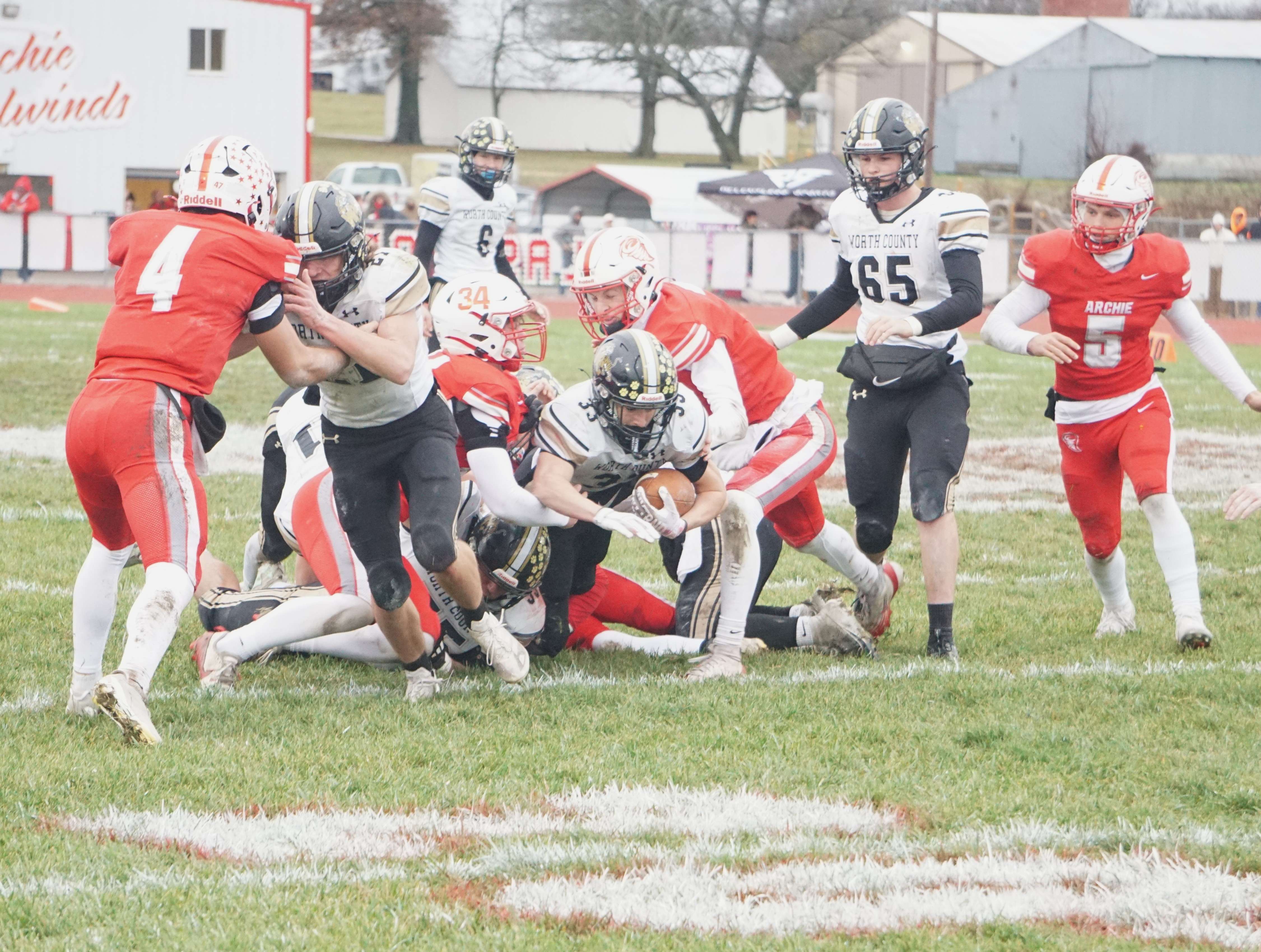 Cole Ruby (33) runs through the middle and is dragged down by the Archie defense/ Photo by Matt Pike