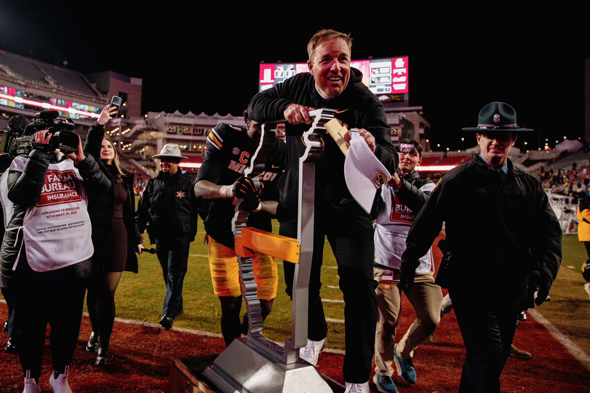 Missouri head coach Eli Drinkwitz rides off on the Battle Line rivalry trophy after Mizzou defeated Arkansas 31-17 on Saturday/ Photo courtesy of Mizzou Football on X