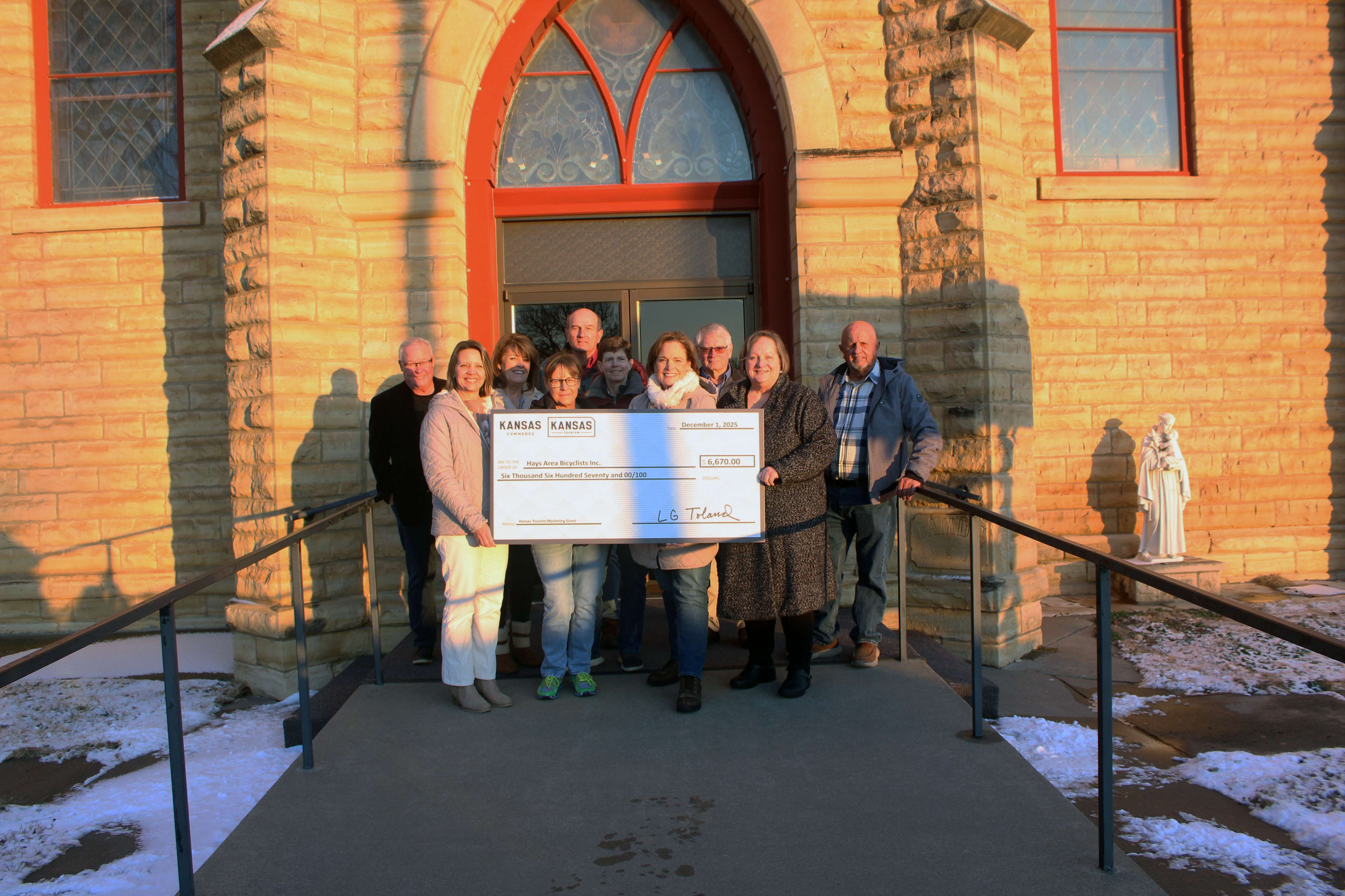 Members of the&nbsp;Tour die-Kapellen met with representatives of the Kansas Department of Tourism on Monday at St. Anthony Catholic Church in Schoenchen to receive a state grant. Pictured (not in order) are&nbsp;Tour die-Kapellen committee members Kay Werth, Helen Hands, Ron Leiker, Tom Dinges, John Braun, Dick Werth and Vicky Sauer; and Jolene Zimmerman of St. Anthony's Church; Melissa Dixon, director of the Hays Convention and Visitors Bureau; and Bridgette Jobe, director of the Kansas Department of Tourism. Photo by Cristina Janney/Hays Post
