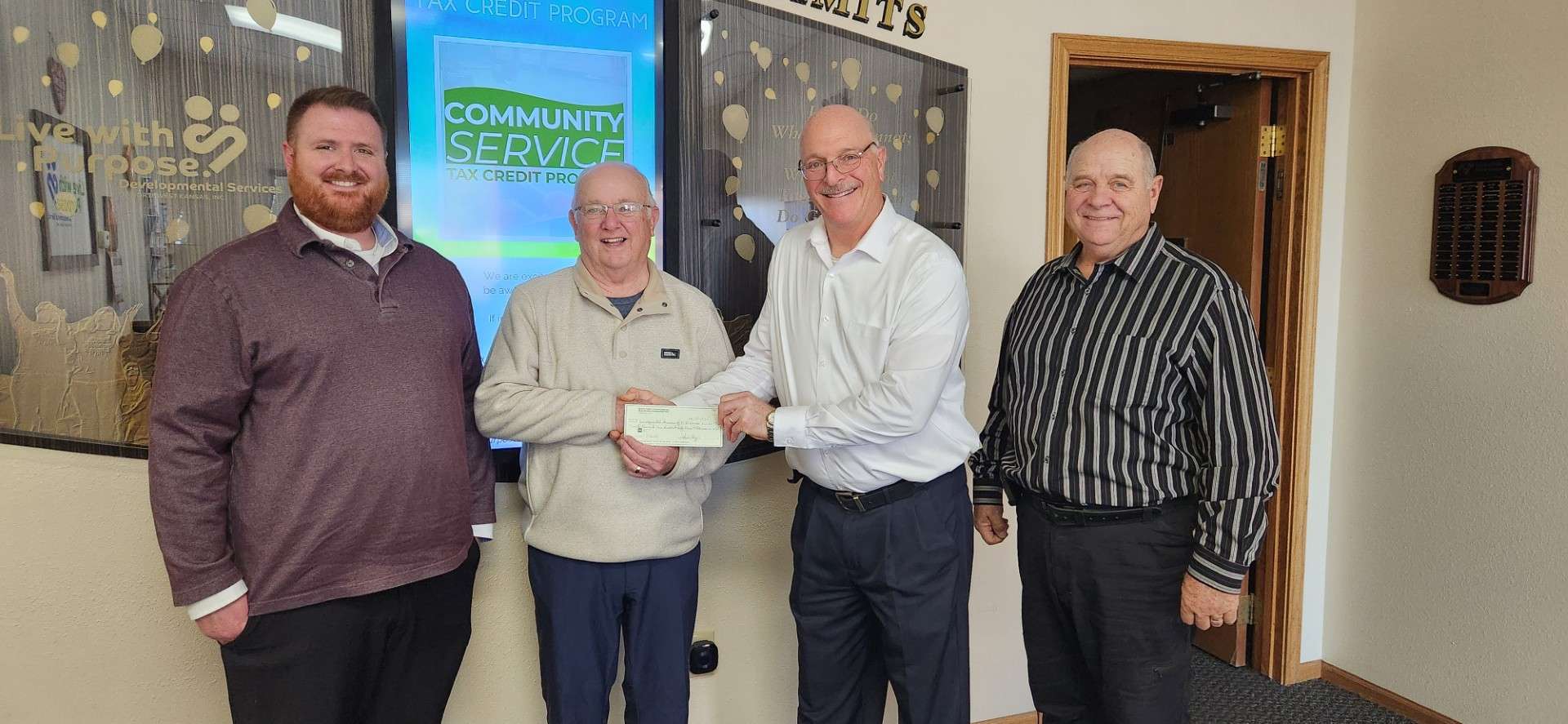 Adam Kober, DSNWK Major Gifts and Planned Giving Officer, Grady Boulier, Beach Family Foundation, Jerry Michaud, DSNWK President, and Allen Schmidt, DSNWK Major Gifts and Planned Giving Officer. Photo courtesy&nbsp;<i>Developmental Services of Northwest Kansas</i>