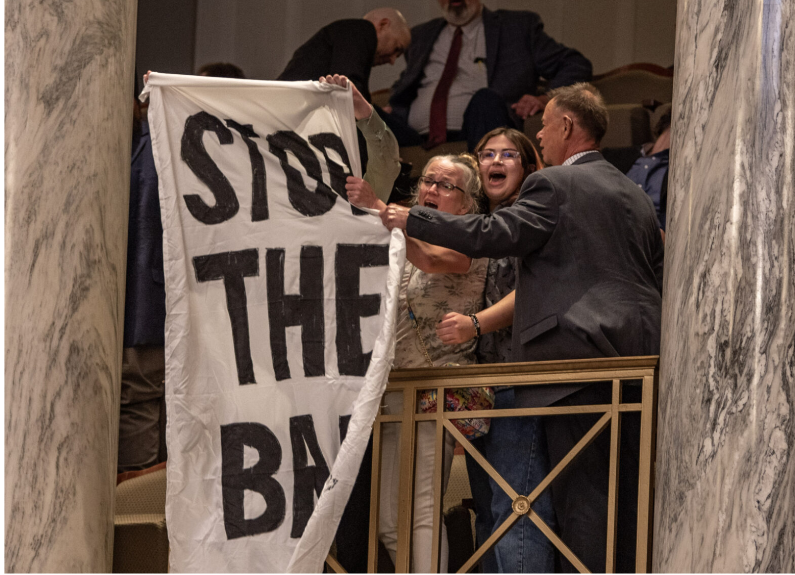 Missouri Senate security shuts down protestors with a "stop the ban" banner in the Senate's upper gallery on May 14 following a vote to put a proposed abortion ban on the statewide ballot (Annelise Hanshaw/Missouri Independent).