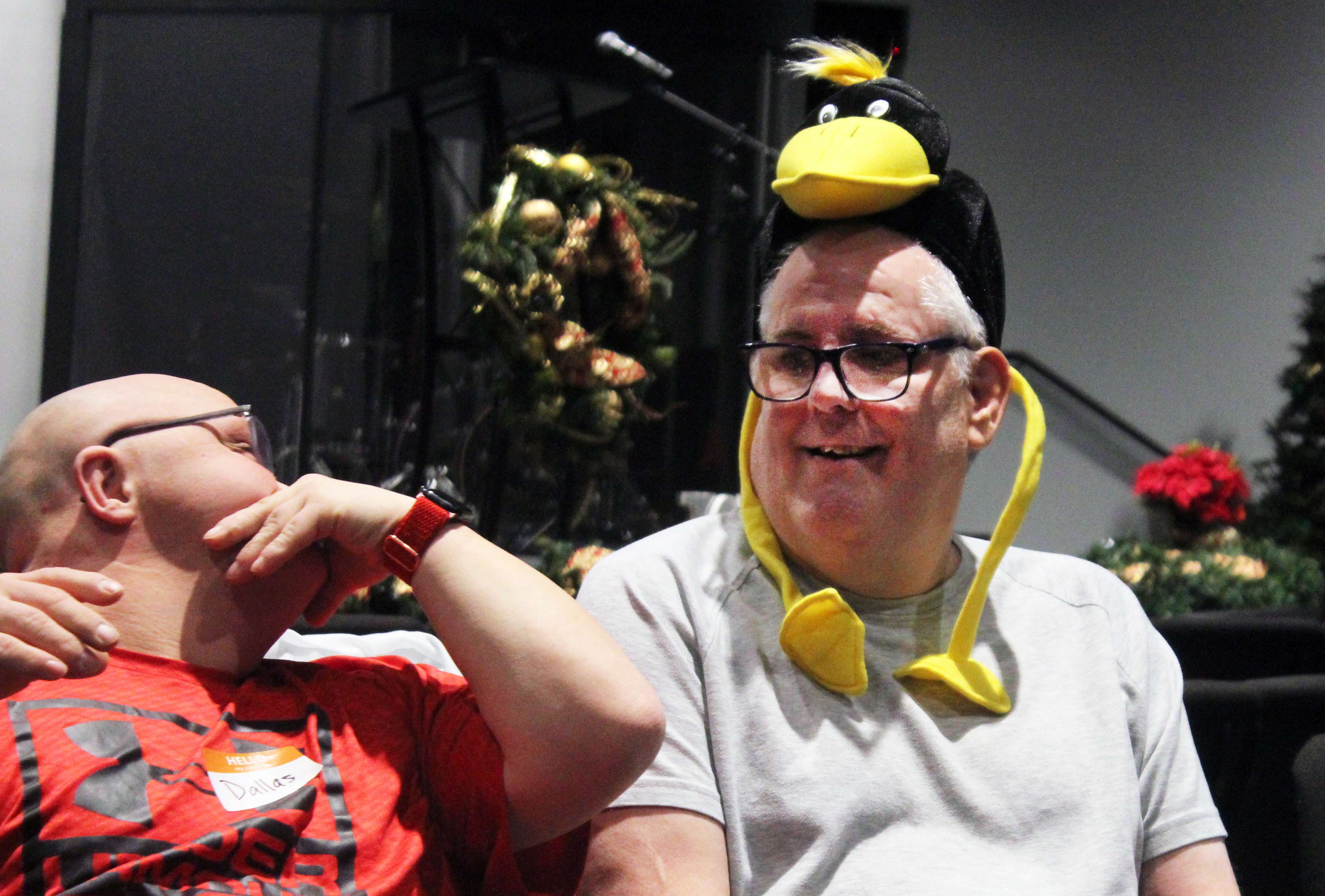 Camper Jimmy, right, takes a turn at Pass the Hat as fellow camper Dallas looks on. Photo by Cristina Janney/Hays Post