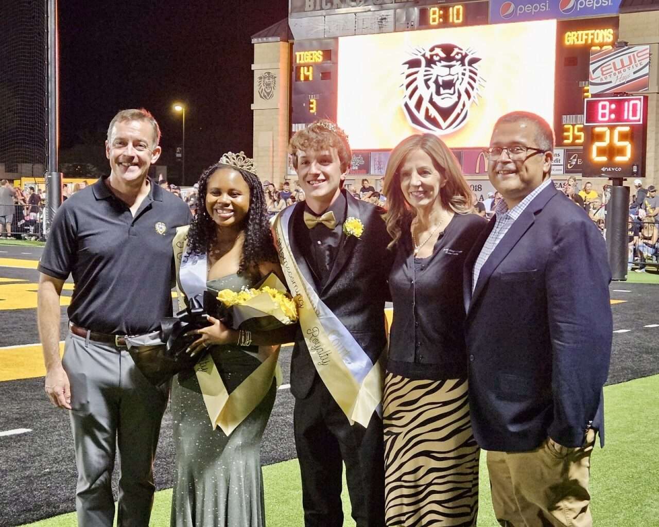 Fort Hays State University President Tisa Mason with students Cade Becker and Star Parham, 2025 FHSU homecoming king and queen, at Lewis Field Stadium. Courtesy photo