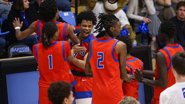 Blue Dragon teammates congratulate Lolo Rudolph (0) after hitting a game-winning 3-pointer at the buzzer for a 58-57 Hutchinson victory over No. 15 Barton on Wednesday in Great Bend. (Billy Watson/Blue Dragon Sports Information)