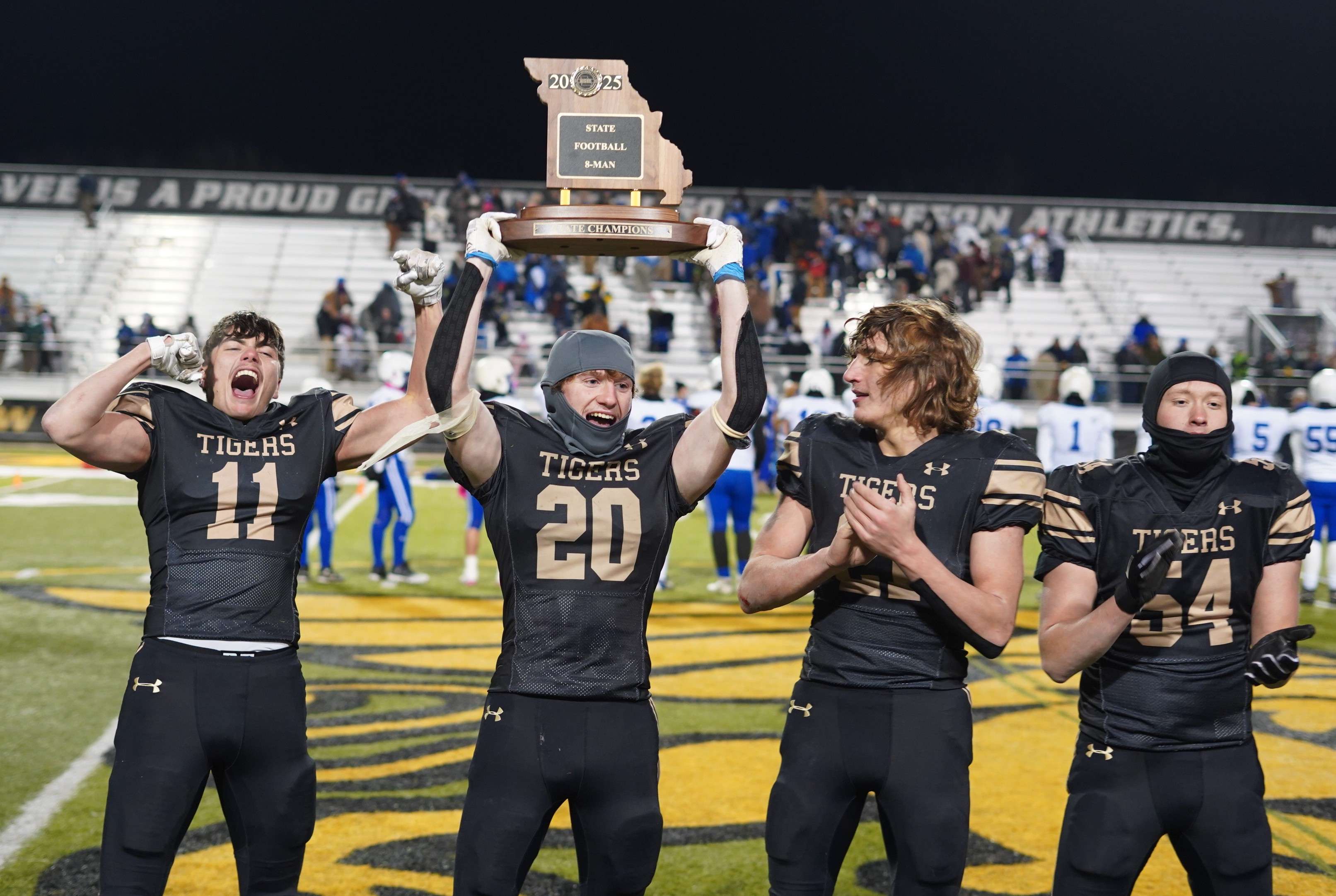 Seniors Brayden Stevens (20),&nbsp;Sawyer Thurman (11),&nbsp;Lucas Frisch (21), and&nbsp;Brayden Murphy celebrate after Worth County defeated Rock Port 56-46 for the Tigers first state title since 2017/ Photo courtesy of Clifton Grooms