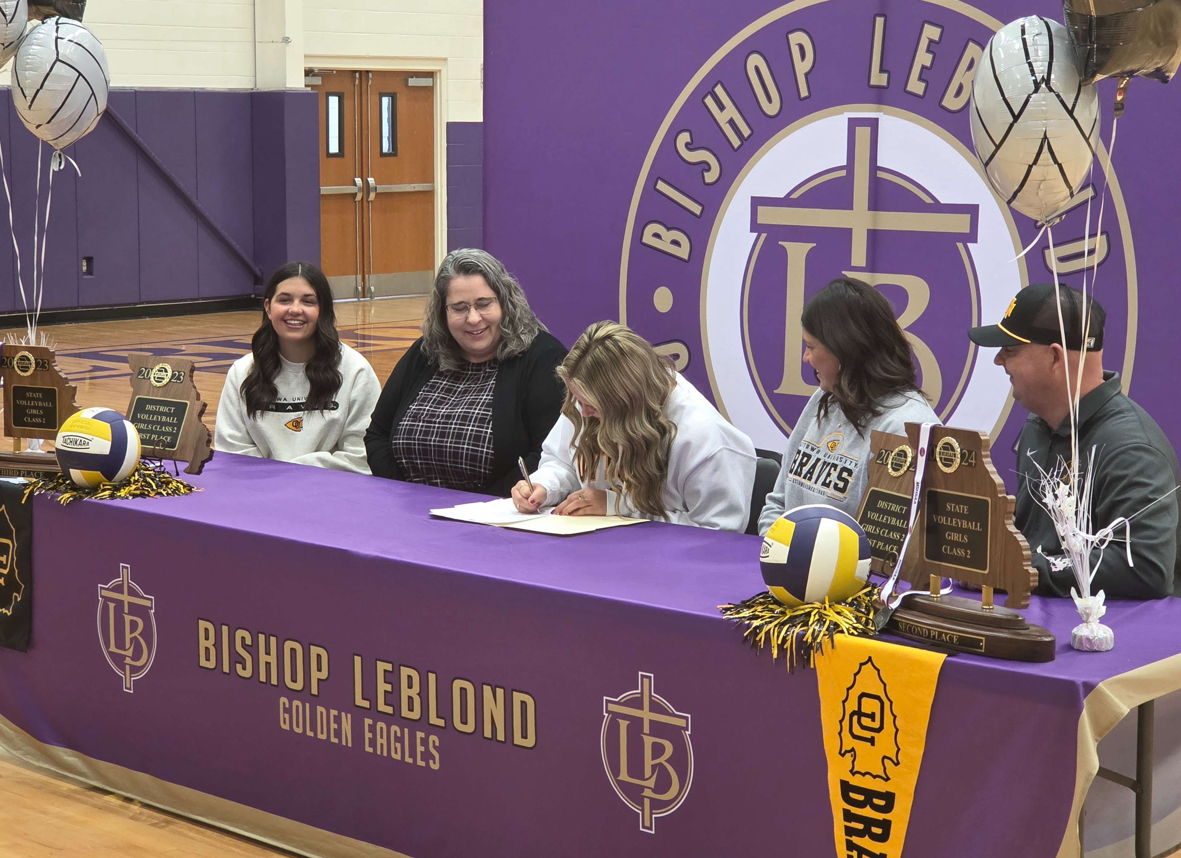 Bishop LeBlond volleyball standout Rilyn Conard, who set multiple records in her time with the Golden Eagles, signs her letter of intent to play volleyball at Ottawa University/ Photo by Matt Pike