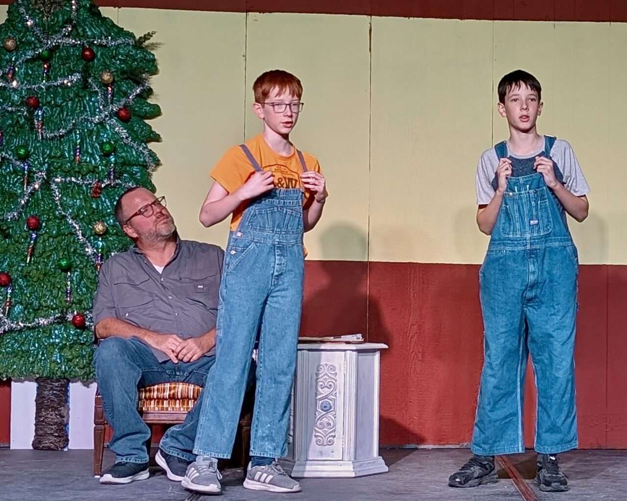 Jeremy McGuire as Joe, the janitor, watches as best friends Brandon (Mattias Miller) and Morgan (Jenson Miller) sing during the “show.” Courtesy of Hays Community Theatre