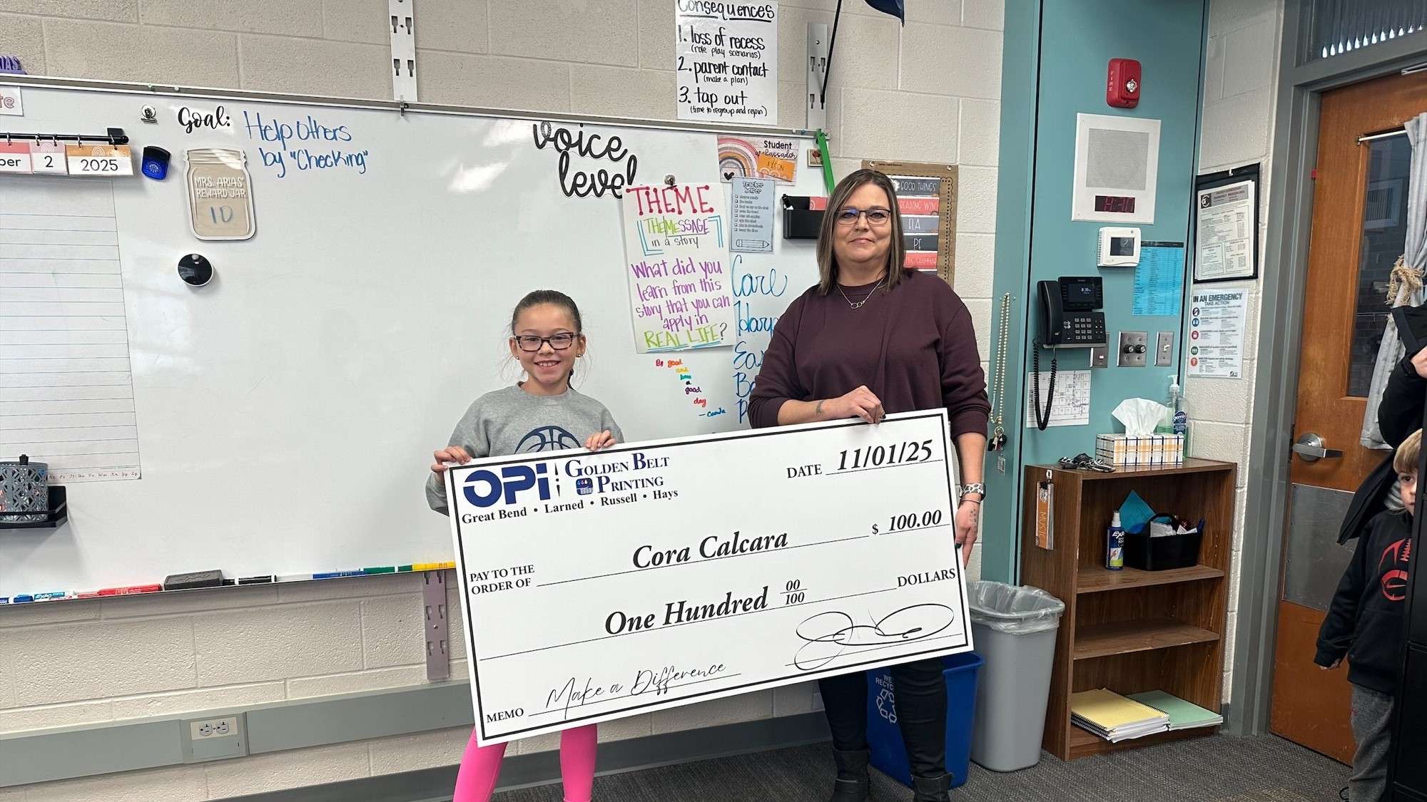 Lincoln Elementary third grader Cora Calcara received a giant $100 check from OPI and Golden Belt Printing as the first December weekly winner in Eagle Media's Make a Difference Contest. Calcara and her teacher, Mrs. Arias, are now eligible for the monthly prize.