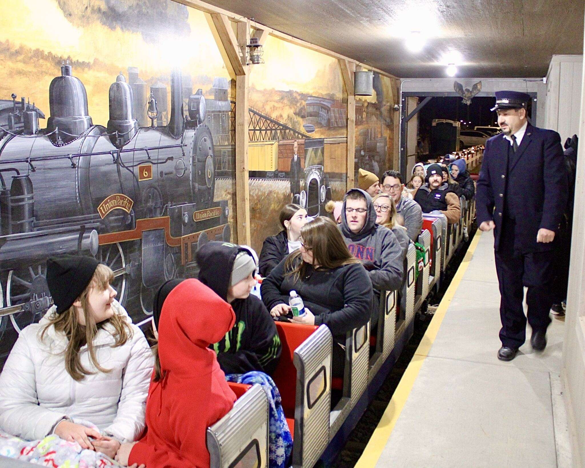 Riders on the Ellis Polar Express with its conductor before departing onto the tracks. Photo by Tony Guerrero/Hays Post.