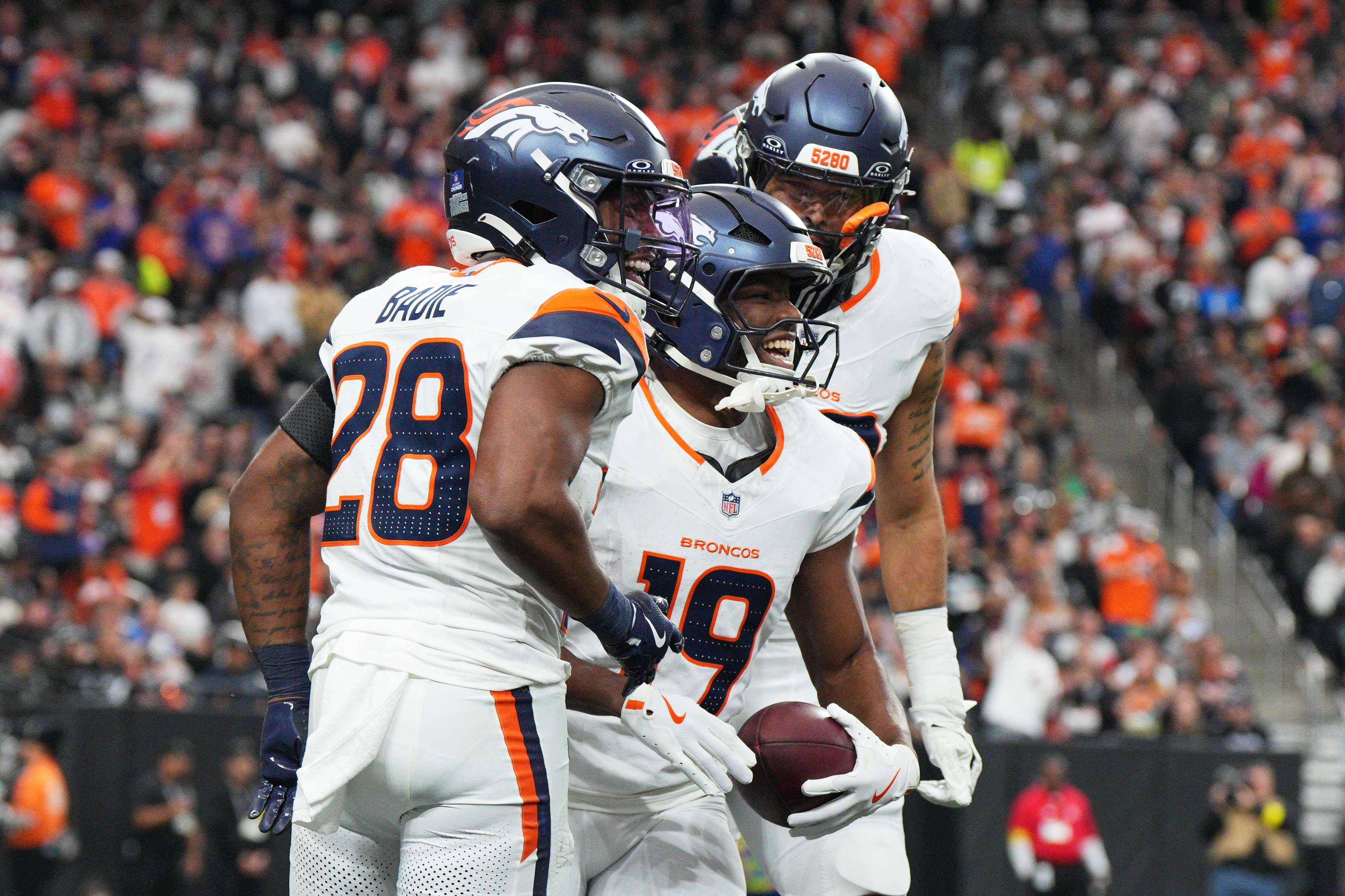 Denver Broncos' Marvin Mims Jr., middle, is congratulated by teammates after returning a punt for a touchdown against the Las Vegas Raiders during the first half of an NFL football game in Las Vegas, Sunday, Dec. 7, 2025. (AP Photo/Candice Ward)