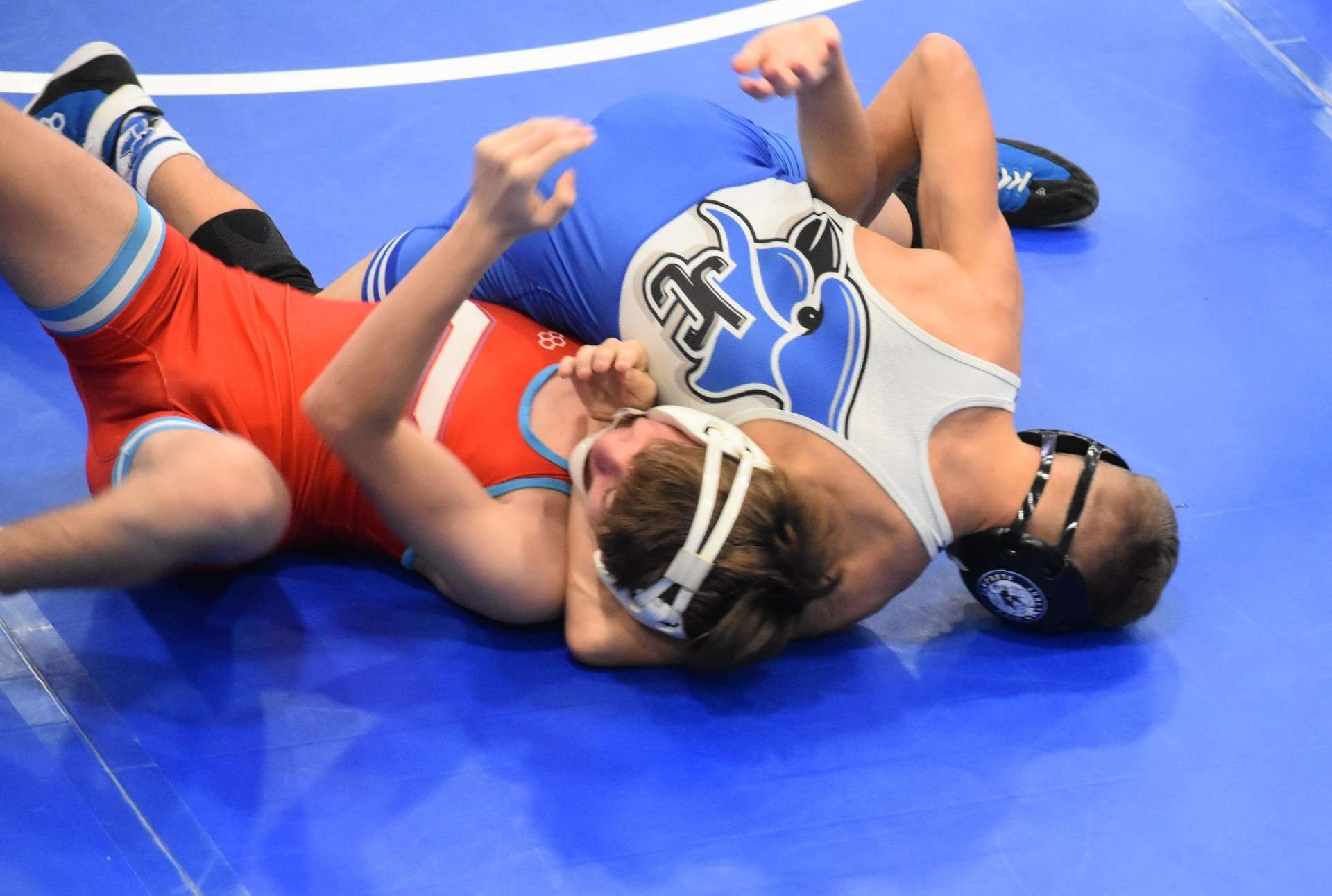 Riley Luckenbill ( Blue and White ) wrestling for the Blue Jays