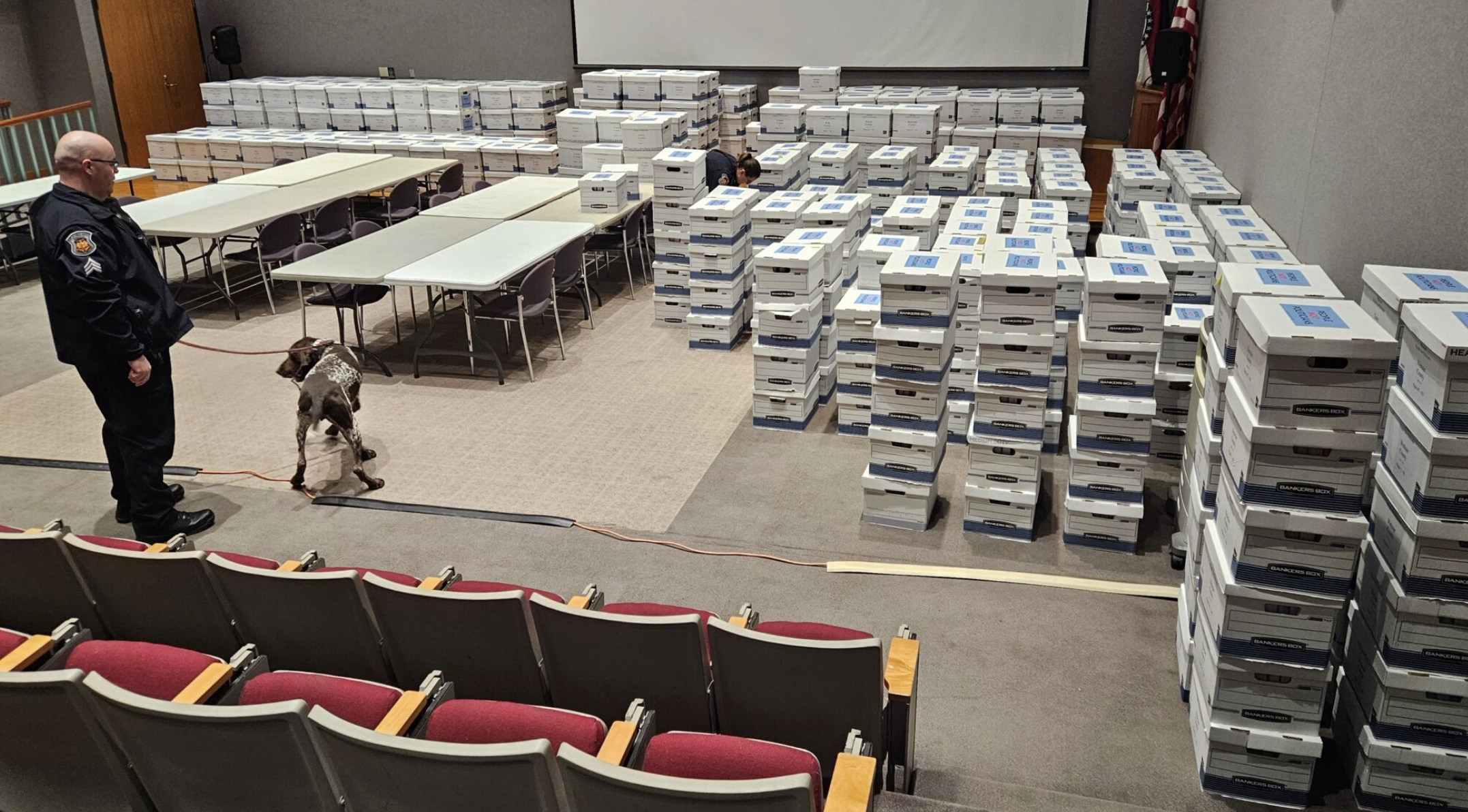 Missouri Capitol Police officers conduct security checks Tuesday on the 691 boxes of petitions filed by People Not Politicians to force a referendum on the gerrymandered Congressional district map passed by lawmakers in September. Of the 27 times a referendum has been placed on the Missouri ballot, voters have rejected the General Assembly’s actions all but twice. (Rudi Keller/Missouri Independent)