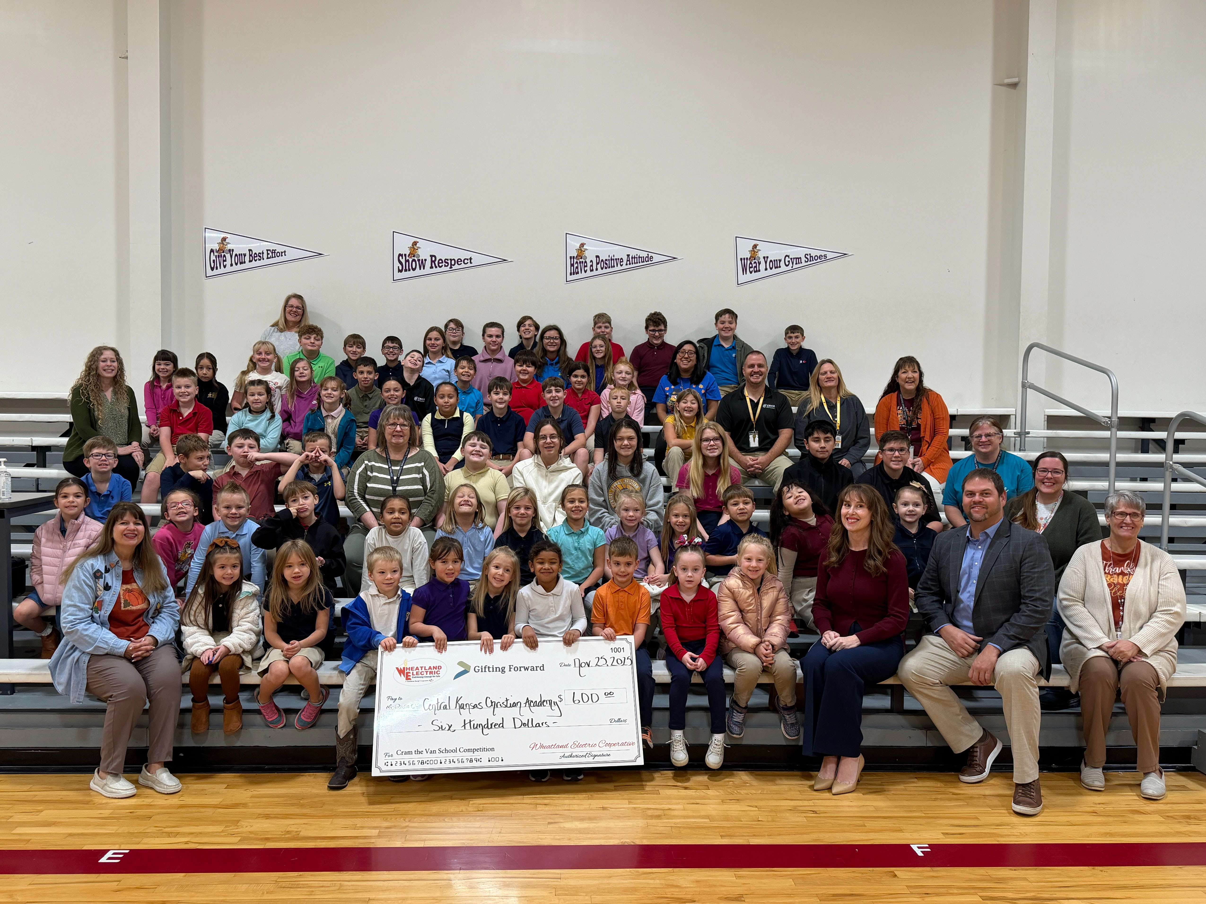 Central Kansas Christian Academy celebrated a first-place finish after collecting 28.13 pounds of food per student. CKCA was rewarded with a $600 cash check from Gifting Forward. Pictured are CKCA students and staff, along with Wheatland Electric's Mary Hoisington and Gifting Forward's Matt and Dena Hiss.