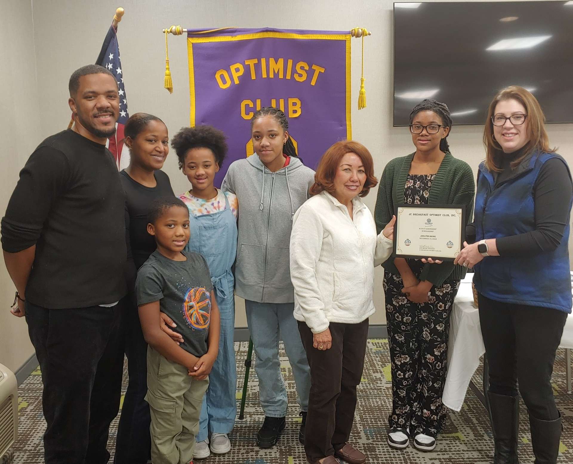 Pictured left to right are Jahvelle Rhone, father; Teandra Rhone, mother; Llogan, brother; Layla and Victoria, sisters of Jaelynn; Nita Miller, JC Breakfast Optimist Club President; Jaelynn Rhone and Crystal Holzer, Junction City High School FSA Counselor