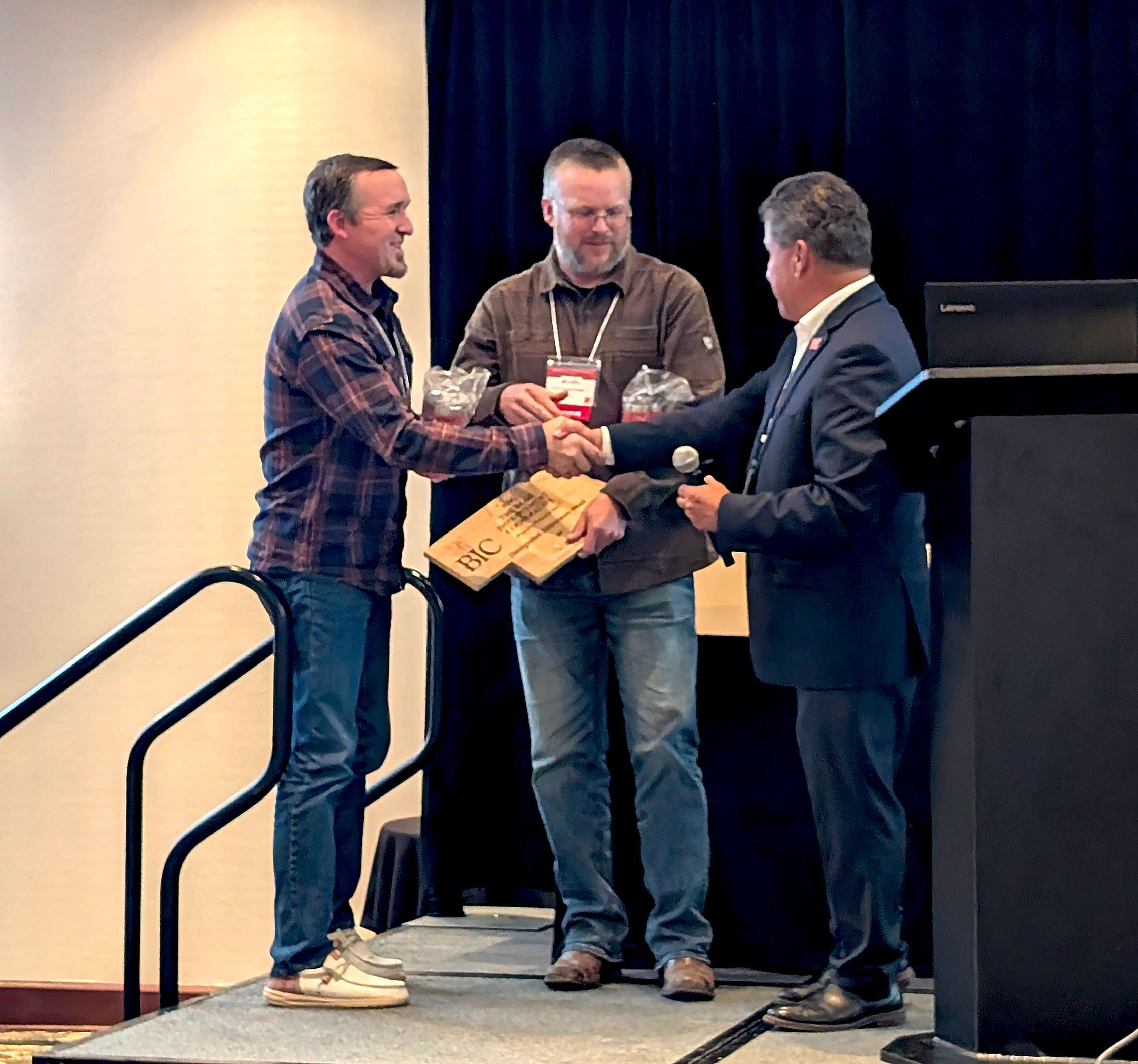 Matt and Luke Shellenberger receive a Distinguished Achievement Award In Memory of Ron Shellenberger from Carlos Urrea. Courtesy Photo