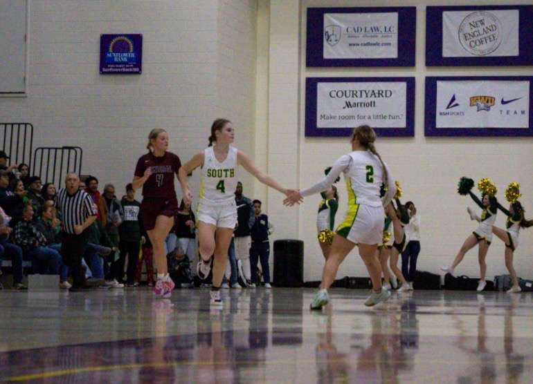Kyla Hamel high fives Brooklyn Jordan after knocking down a crucial three-pointer. Photo by Kaiden Comeau.