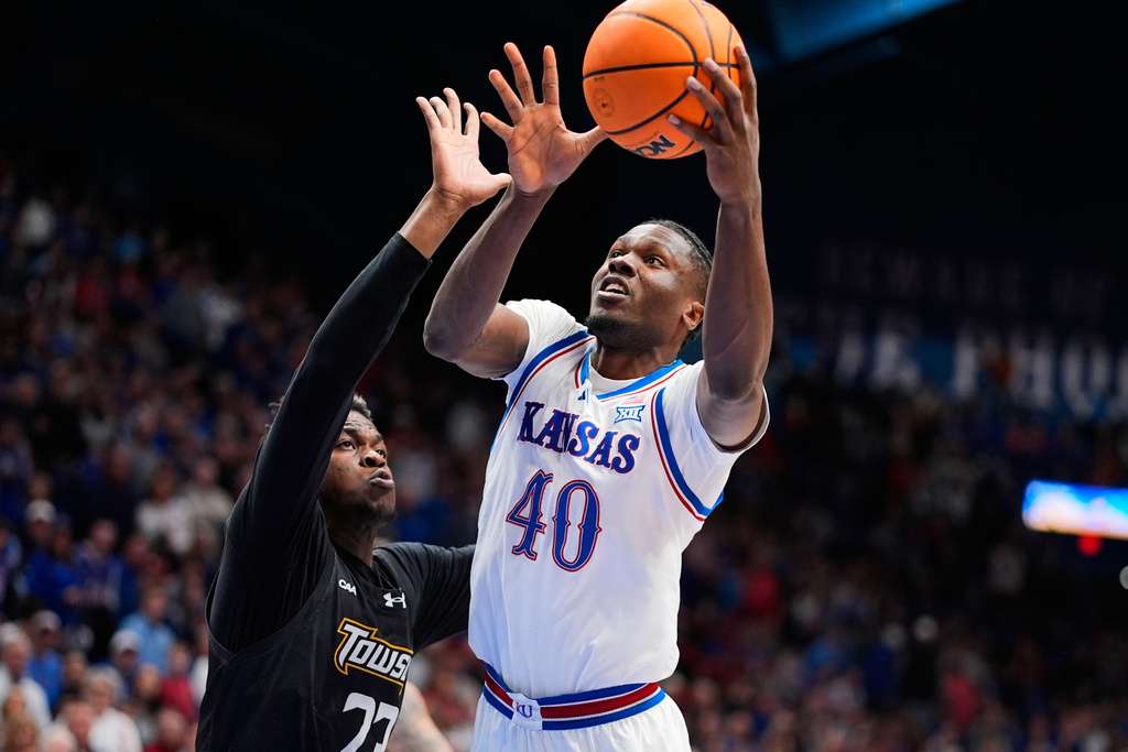 Kansas forward Flory Bidunga (40) shoots over Towson forward Caleb Embeya (23) during the first half of an NCAA college basketball game Tuesday, Dec. 16, 2025, in Lawrence, Kan. (AP Photo/Charlie Riedel)