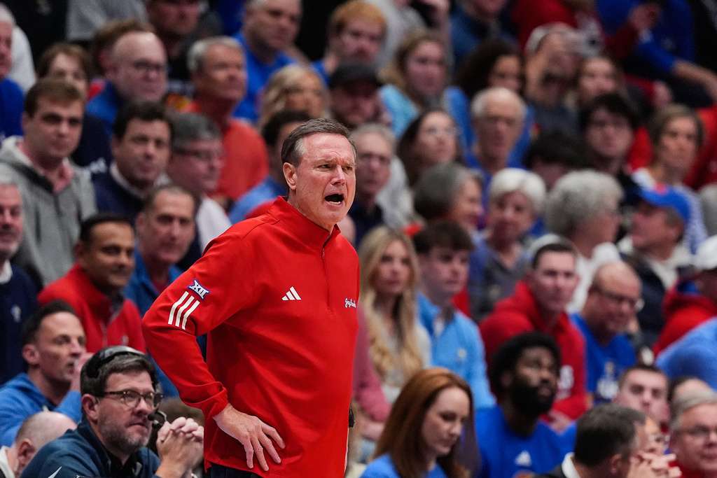 Kansas head coach Bill Self talks to his players during the first half of an NCAA college basketball game against Towson, Tuesday, Dec. 16, 2025, in Lawrence, Kan. (AP Photo/Charlie Riedel)