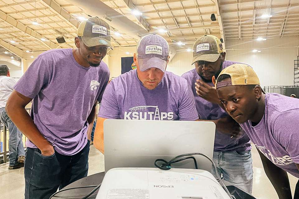 As part of K-State's Testing Ag Performance Solutions team, Rayhaan Kabenge, left, is building tools powered by artificial intelligence that help farmers turn complex data into clear decisions. (Photo courtesy K-State Research and Extension)