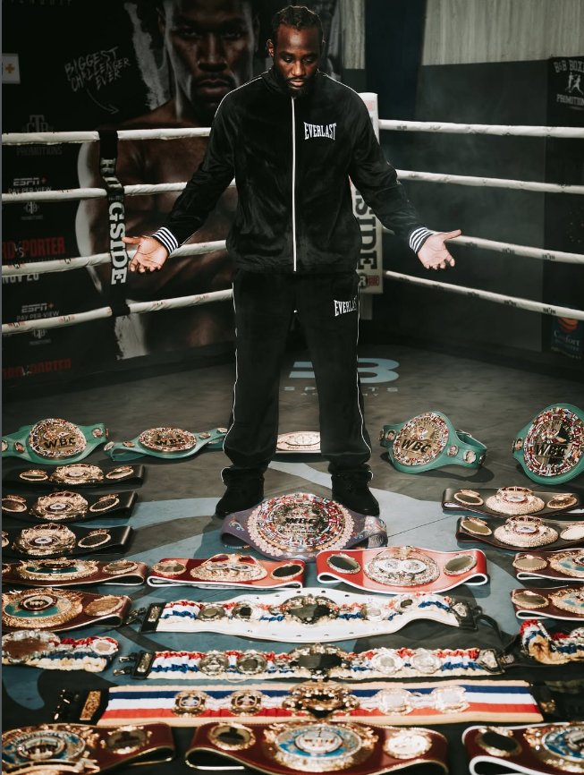 Terance "Bud" Crawford stands with his title belts from his career, shared in an Instagram post that turned out to tease his retirement. (Courtesy Terrance Crawford Instagram)