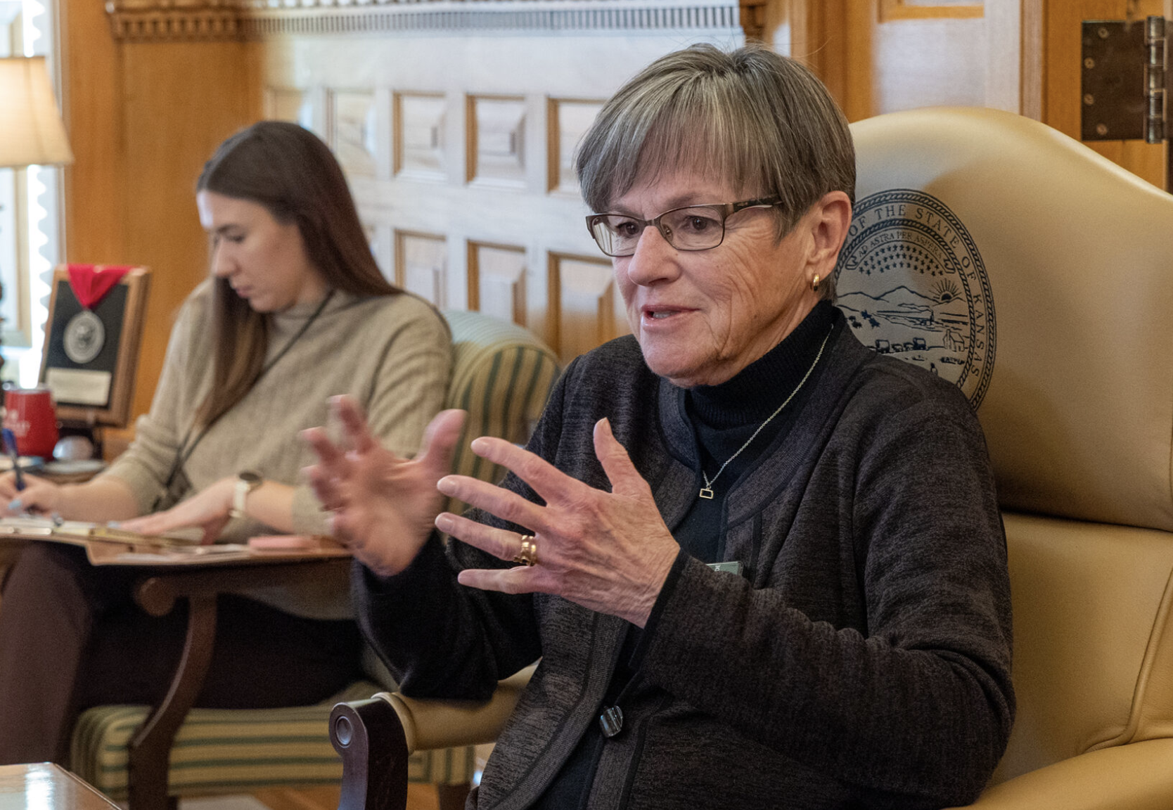 Gov. Laura Kelly answers questions from Kansas Reflector senior reporter Tim Carpenter during a Dec. 16, 2025, interview at her office in the Statehouse. (Photo by Sherman Smith/Kansas Reflector)