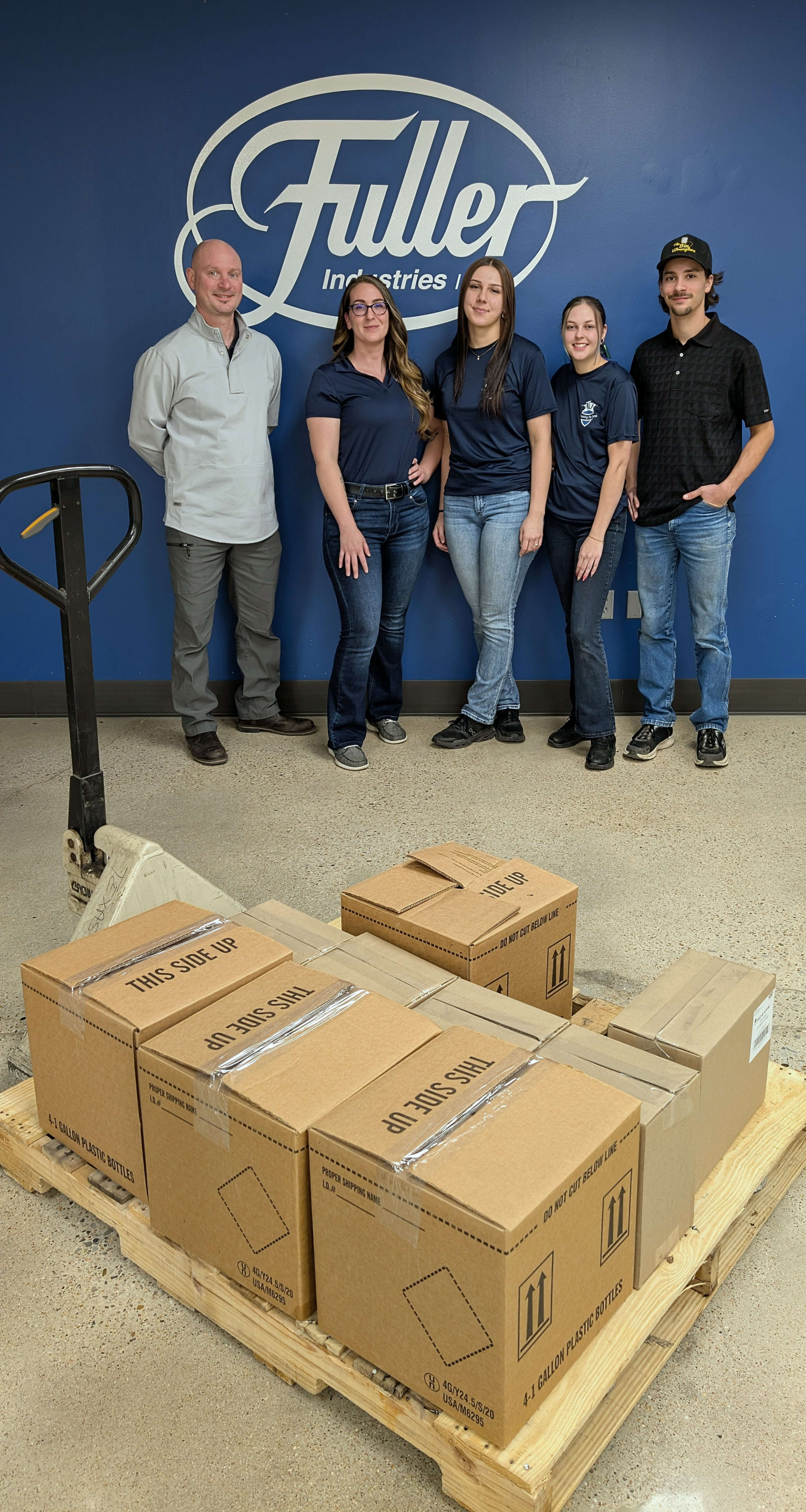 Fuller Industries Inc. General Manager Joe Mann, left, donates an assortment of cleaning products to Cleaning By Jess owner Jessica Lysinger, second from right, Tuesday at the Fuller plant in Great Bend. Also pictured are Cleaning By Jess employees Abi Furlong and Phoebe Perkins, and Bin Wranglers owner Wrangler Walker. The companies have partnered to provide no-cost cleaning services for local residents in need.