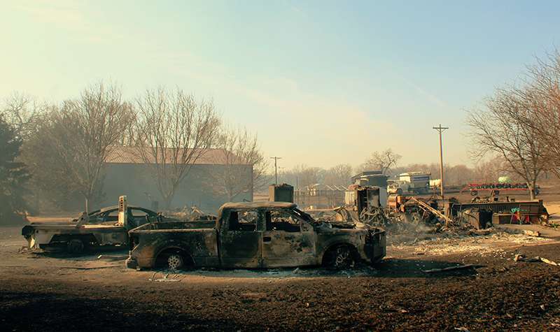 The burned out shells of vehicles at a home in Paradise. Photo by Cristina Janney/Hays Post