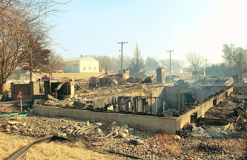 The burned out shell of a home in Paradise. The metal lawn furniture was still sitting on the front porch. Photo by Cristina Janney/Hays Post