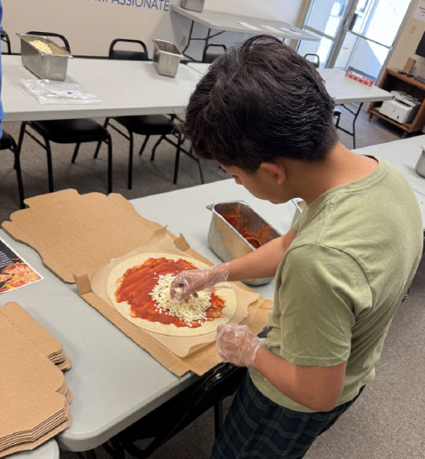 A client at Juvenile Services whips up a pizza during a recent Life Skills class.