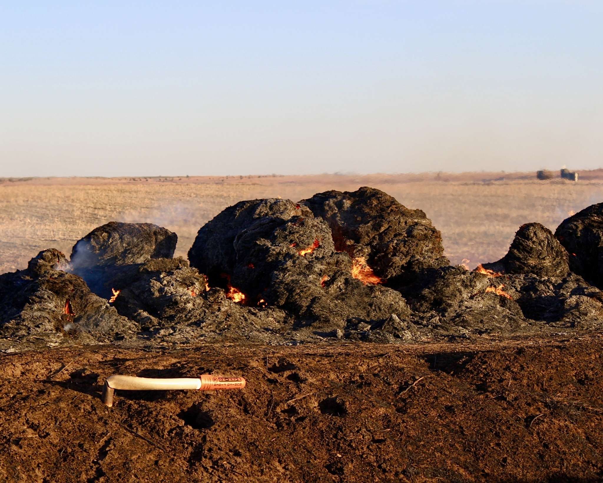 Compacted hay or feed bale smoldering after the Russell County fire. Photo by Tony Guerrero/Hays Post