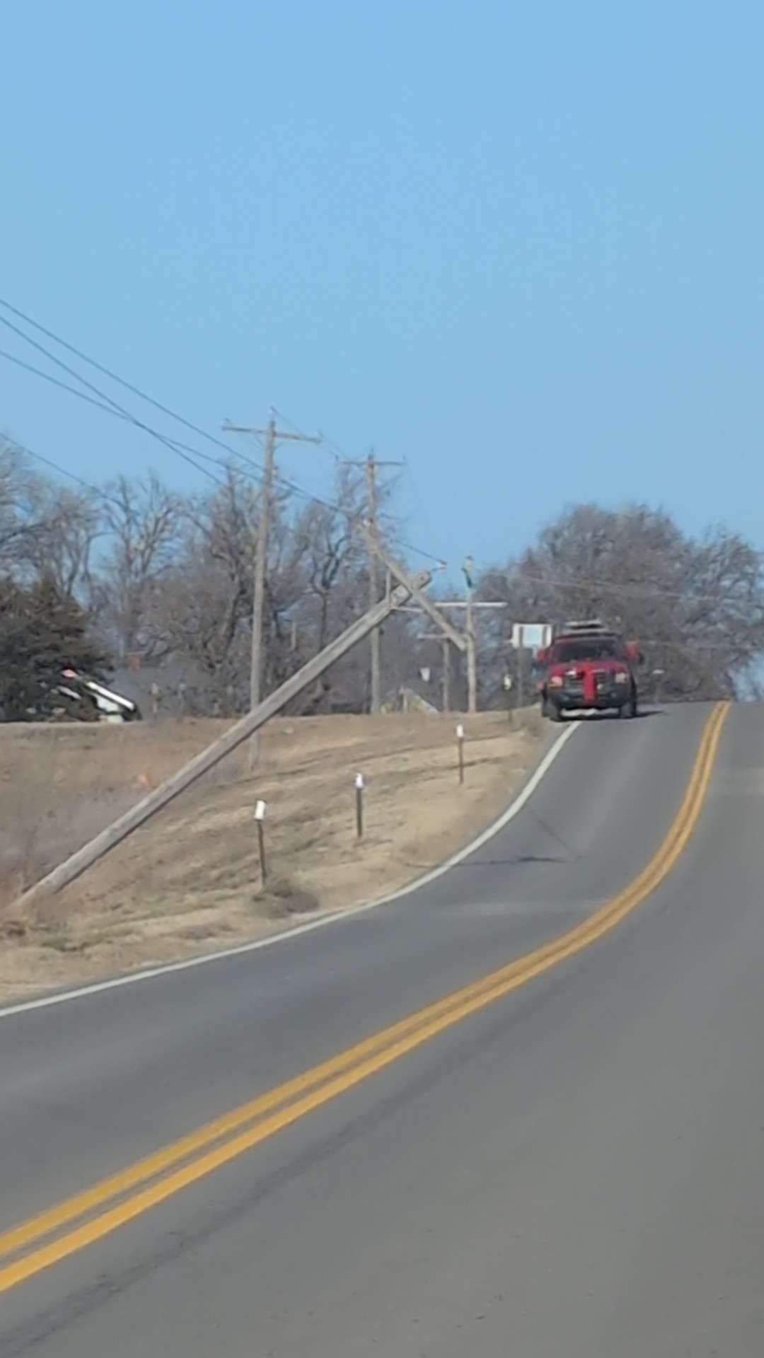 Evergy power pole leaning across the road in the 7600 block of Gypsum Road in Gypsum, KS on Thursday, December 18. Photo by Saline County Sheriff's Office