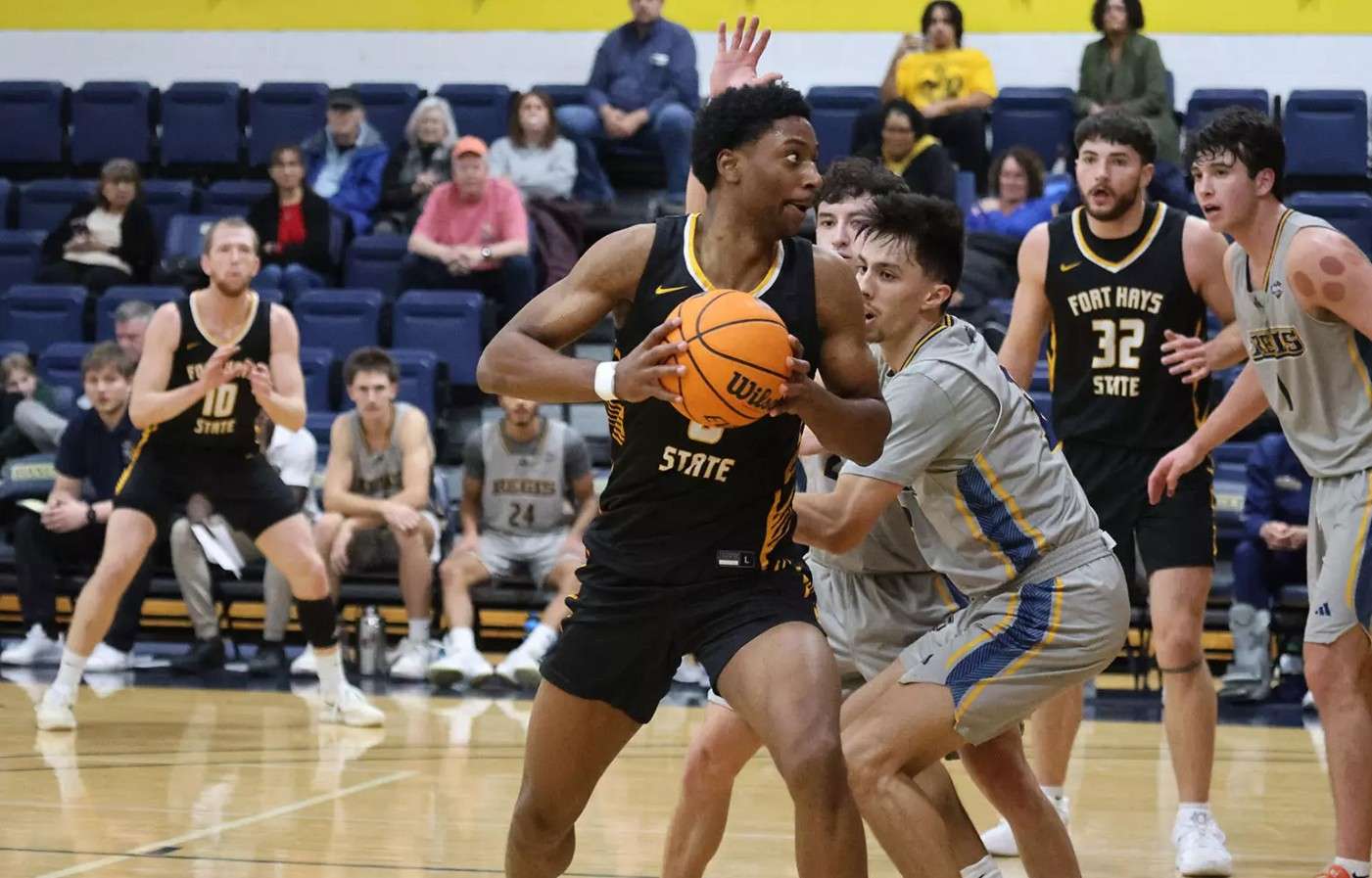 Fort Hays State's Dan Makuna makes a move towards the basket against Regis on Saturday, December 20, 2025 in Denver, Colo. (FHSU Athletics photo/Regis Athletics photo)