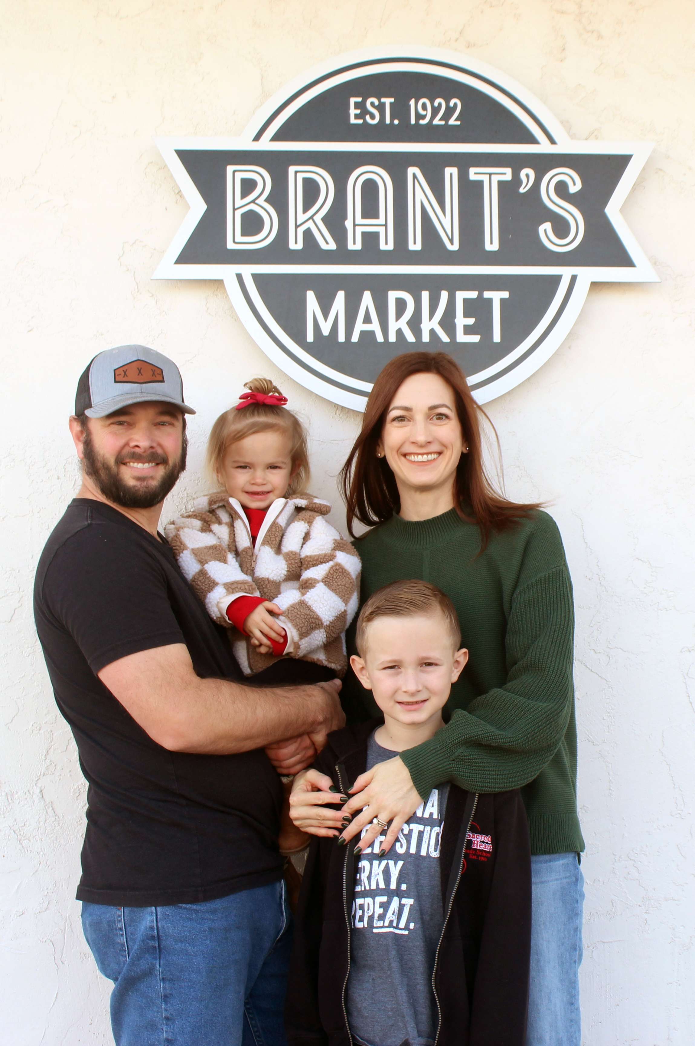 Adam and Ashley Comeau and their daughter, Hollis, 2, and Calvin, 7, at Brant's Meat Market in Plainville. The market offers award-winning meat products made from Kansas-sourced beef. Photo by Cristina Janney/Hays Post