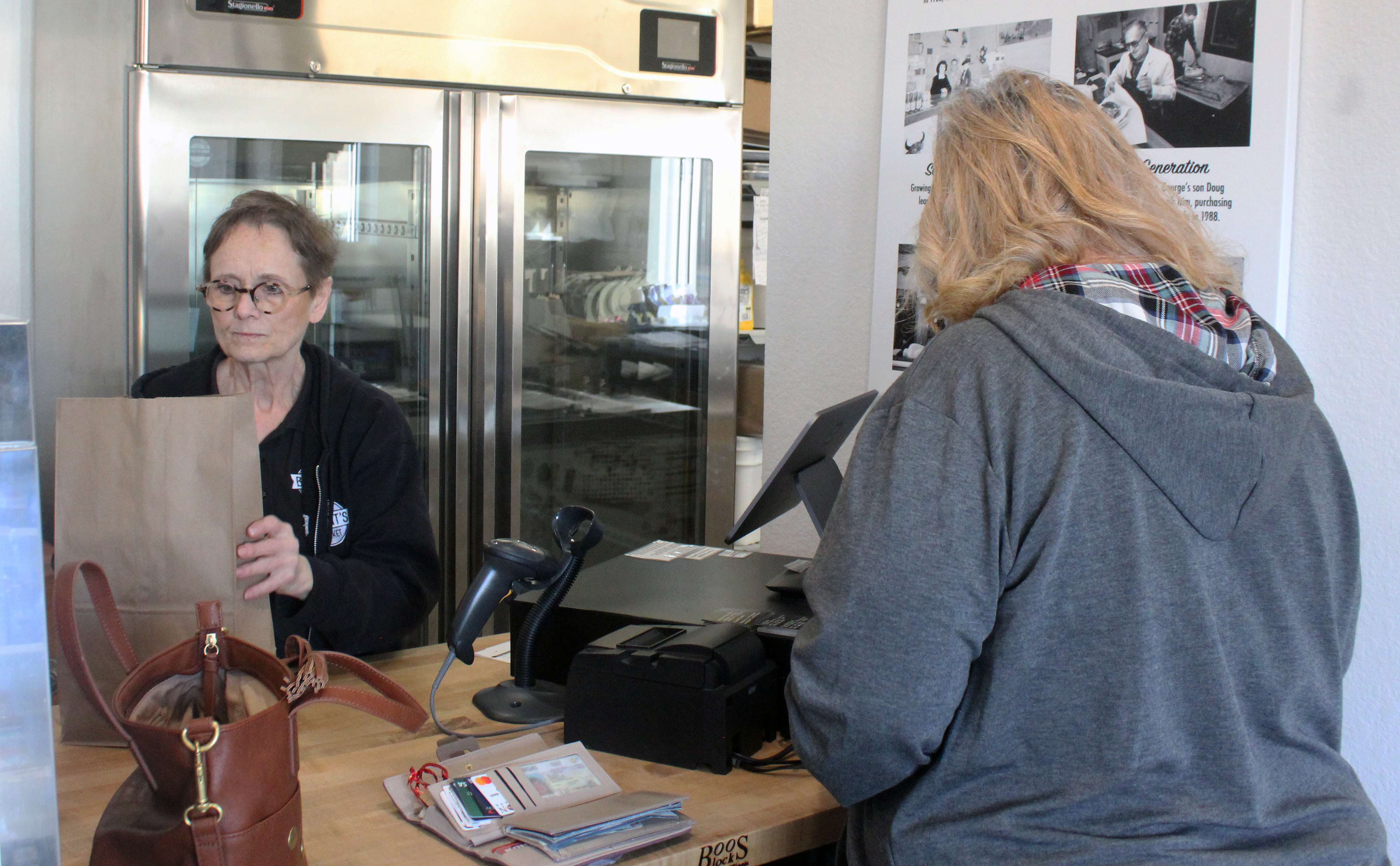 Shirley Comeau, co-owner Adam Comeau's mother, helps a customer at the Plainville store. Photo by Cristina Janney/Hays Post