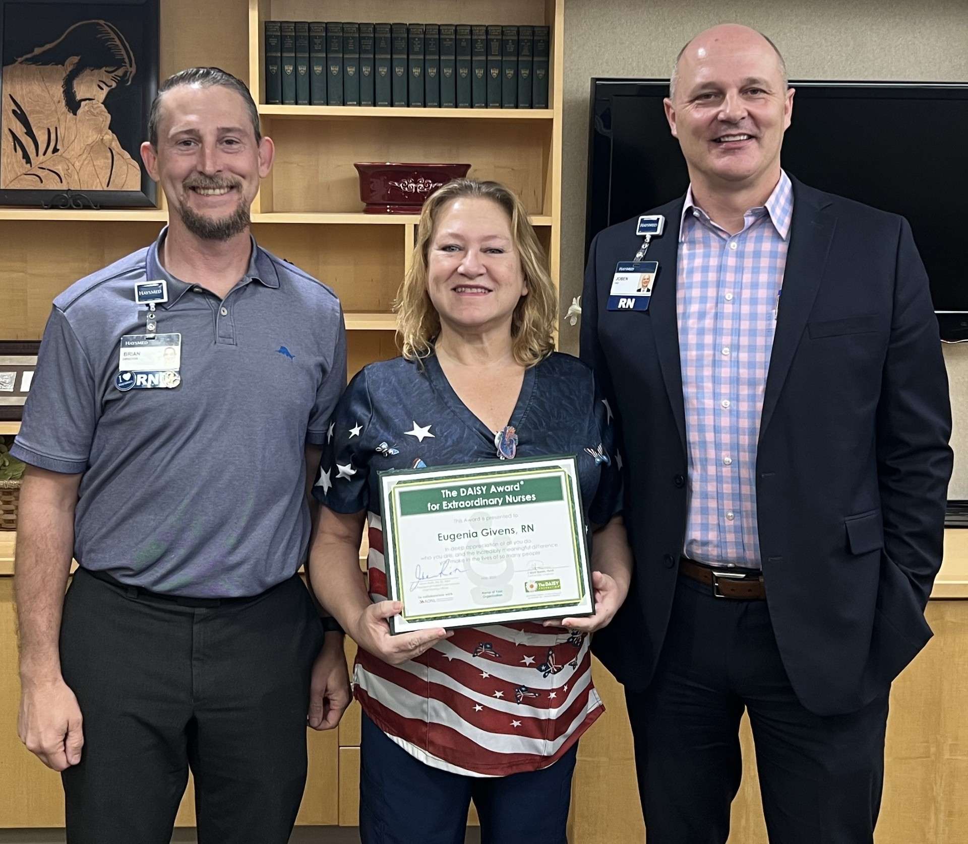 Brian Pfannenstiel, Director of Critical Care, Gina Givens, RN, recipient of the DAISY Award, and Joben Rieth, Vice President of Patient Care Services and Chief Nursing Officer. Courtesy of HaysMed