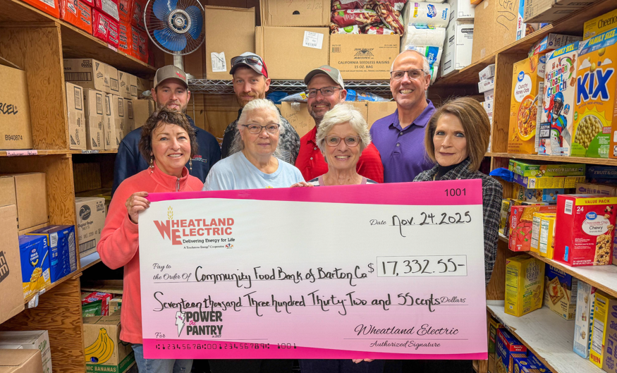Representatives of Wheatland Electric (backrow, left to right) Kreyton Demel and Chris Oliver, line foremen, Dax Walk, district manager, John Sullivan, trustee, and Maribeth Benker, trustee (pictured in the front row, far right), present a check for $17,332 to the Community Food Bank of Barton County volunteers. Pictured in the front row (left to right) are Marsha Gillenwater, Kathy Levingston, and Ruth Behrens, representatives of the food pantry. 