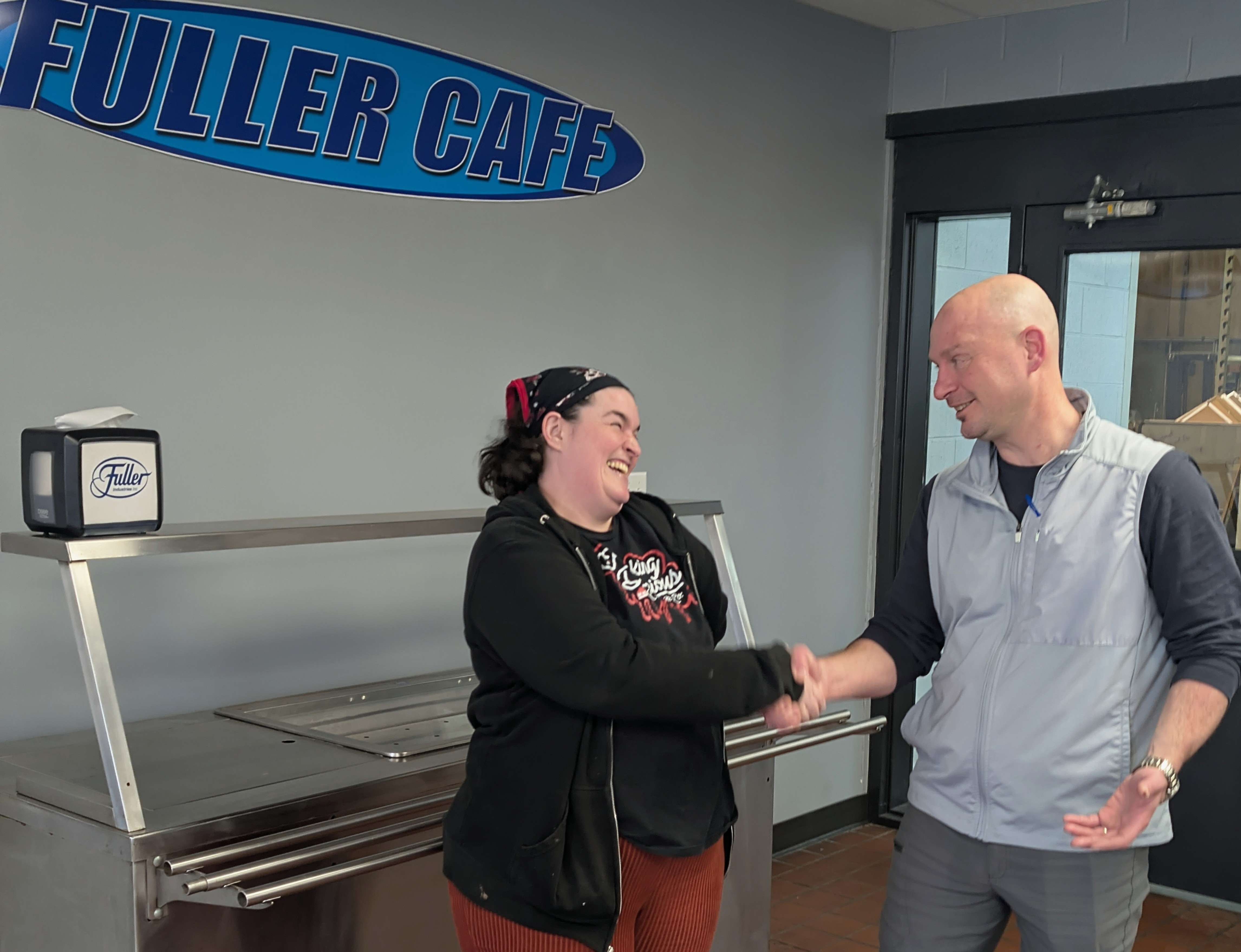 Allie Cartwright, owner of Freaking Delicious Cheesecakes, discusses her arrangements to use Fuller Industries Inc.’s commercial kitchen with Fuller General Manager Joe Mann Monday afternoon. 