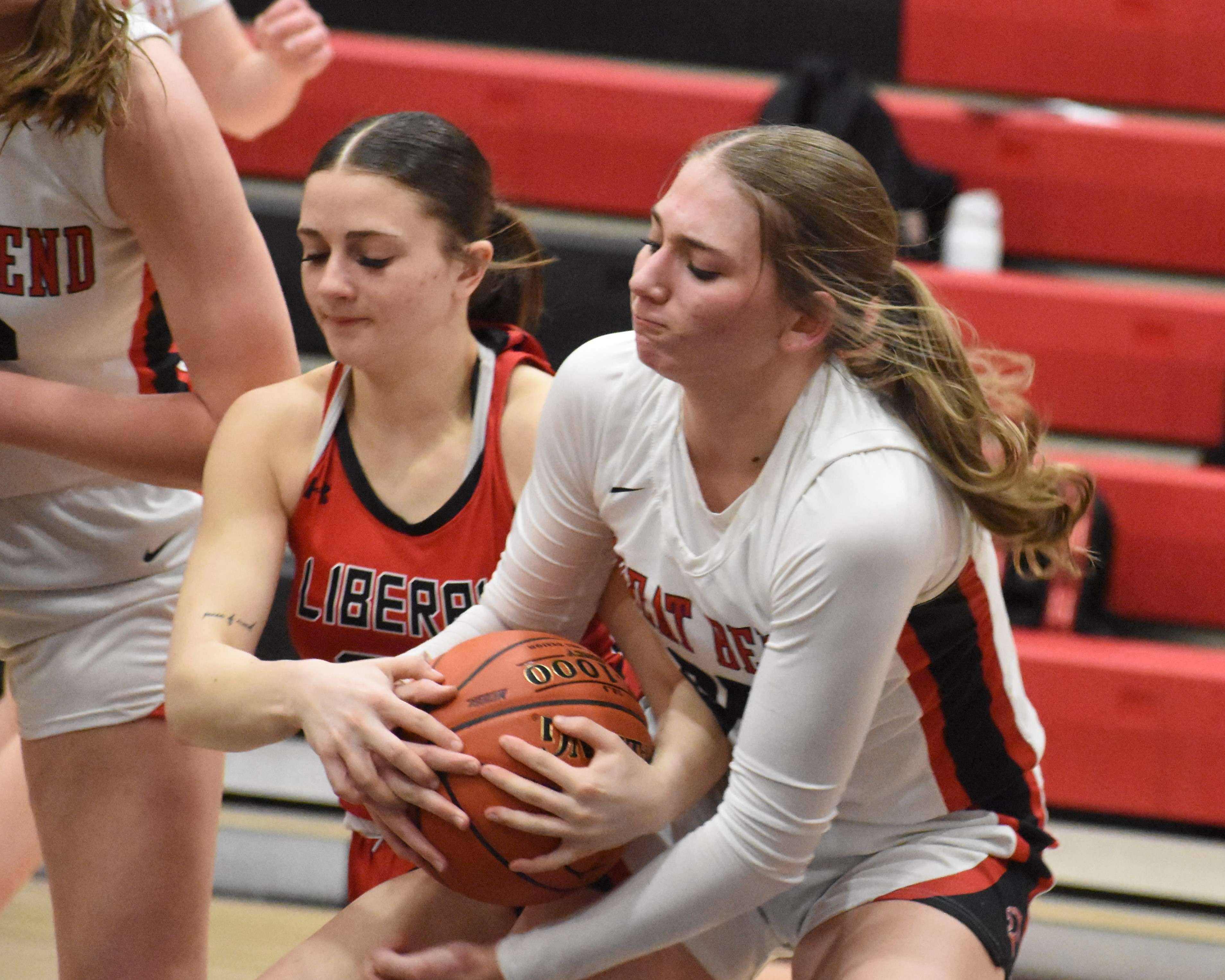 Great Bend junior Katherine Mazouch ties up with Liberal senior Hannah McCarter during Friday's 67-40 loss to the Lady Red.