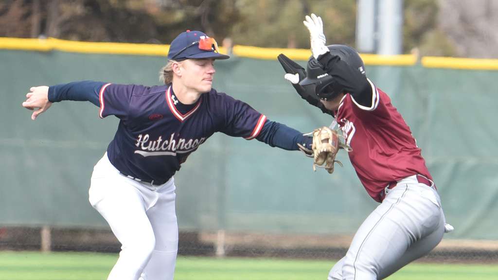 Blue Dragon shortstop Taber Stokes tags out a Hesston runner caught in a rundown between third and home in Game 1 of a season-opening doubleheader sweep of Hesston on Friday at Hobart-Detter Field (Sammi Carpenter/Blue Dragon Sports Information)