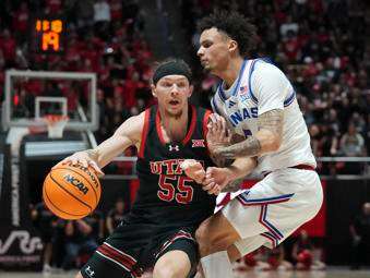 &nbsp;Utah guard Gabe Madsen (55) dribbles around Kansas guard Zeke Mayo (5) during the second half of an NCAA college basketball game, Saturday, Feb. 15, 2025, in Salt Lake City. (AP Photo/Bethany Baker)