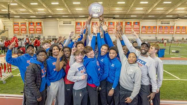 The Blue Dragon men's track and field team celebrate the program's first Region 6 Indoor Championship in team history on Sunday in Pittsburg. (Photo by Ed Bailey)