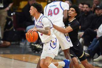 &nbsp;Kansas guard Zeke Mayo, left, drives past forward Flory Bidunga (40) as he blocks Colorado guard RJ Smith in the second half of an NCAA college basketball game Monday, Feb. 24, 2025, in Boulder, Colo. (AP Photo/David Zalubowski)