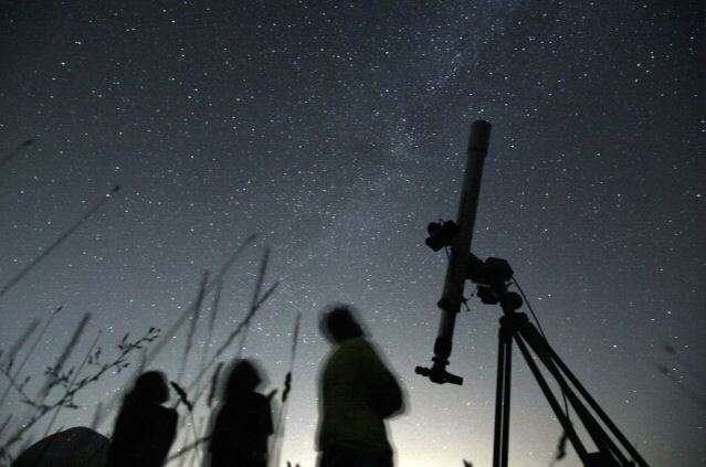 People look up to the sky from an observatory near the village of Avren, Bulgaria, Aug. 12, 2009. (AP Photo/Petar Petrov, File)