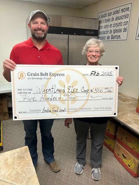 Wheatland Electric Cooperative District 6 Manager Dax Walk (left) and Community Food Bank of Barton County President Ruth Behrens (right) accept a $500 community grant from the Grain Belt Express Community Grant Program. The funding will help replenish essential food supplies, supporting local families facing food insecurity.